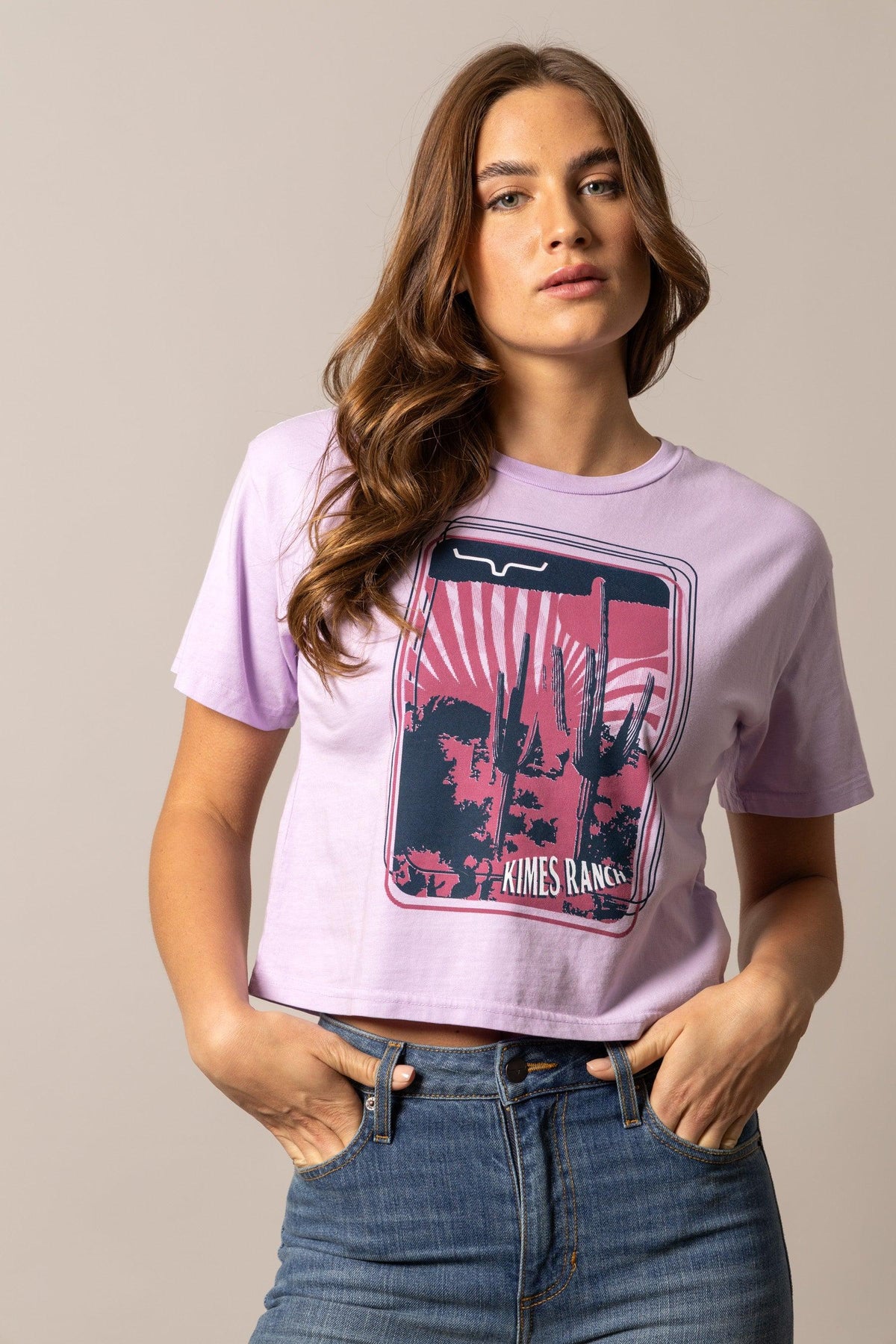 Kimes Ranch Desert Trip shirt in Orchid with a graphic of cacti and a sunset with Kimes Ranch text