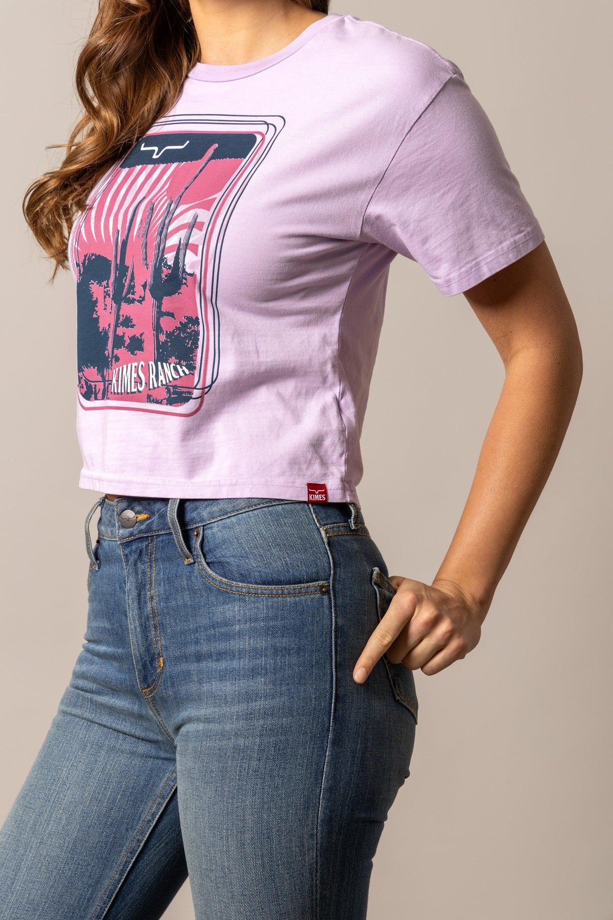 Kimes Ranch Desert Trip shirt in Orchid, side view, with a graphic print of a cactus landscape and the Kimes Ranch logo