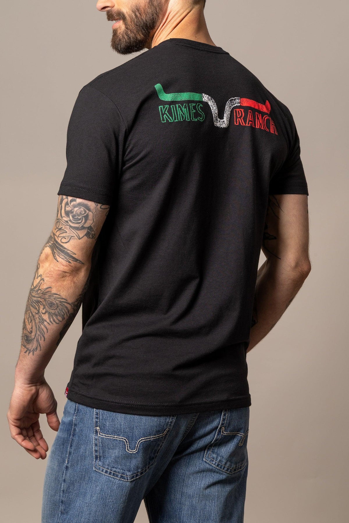 Kimes Ranch Dibujada shirt in Black, back view, with a back graphic featuring the Kimes Ranch logo in green and red