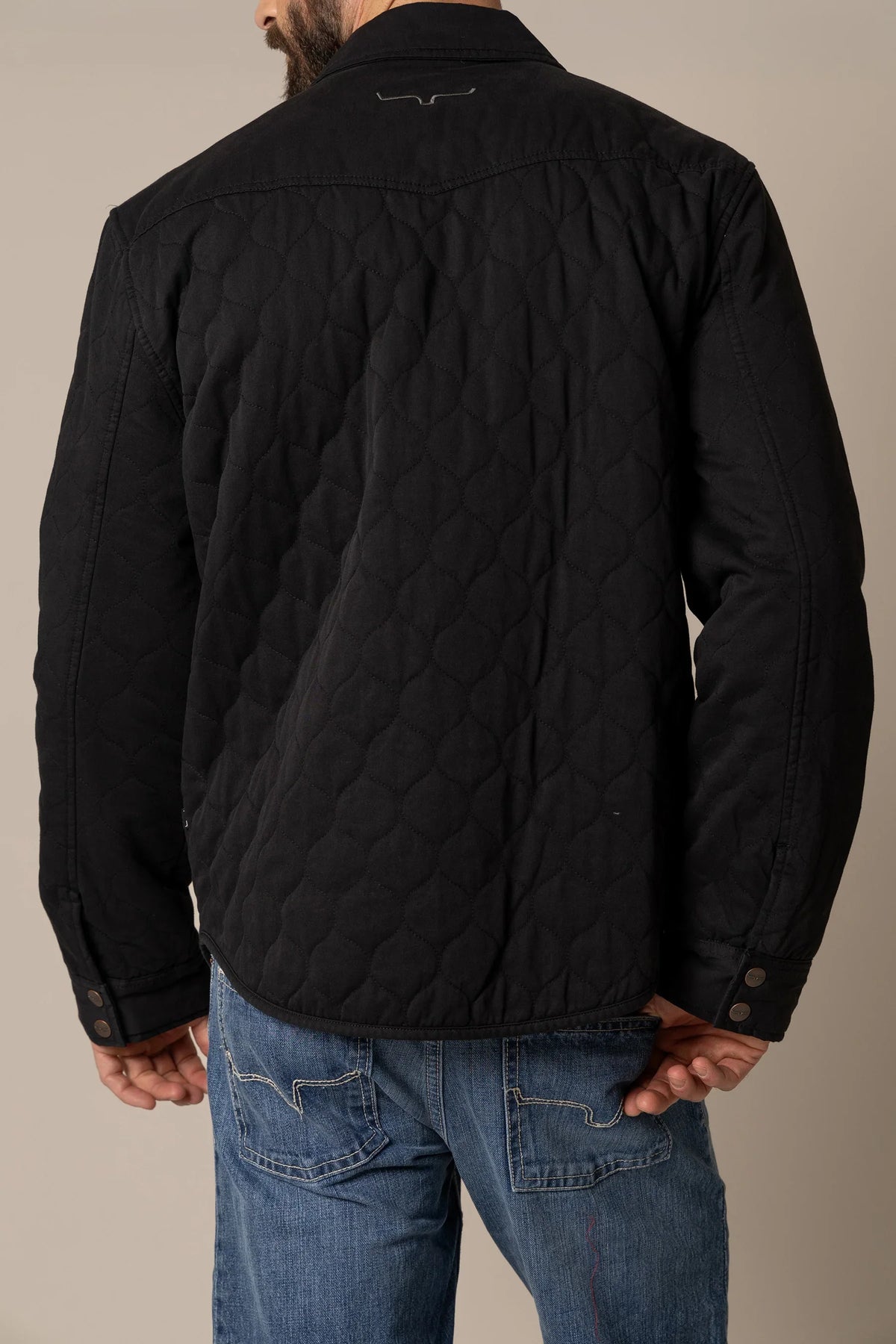 Kimes Ranch Dickson Shacket in Black, back view, with a quilted back yoke and embroidered logo