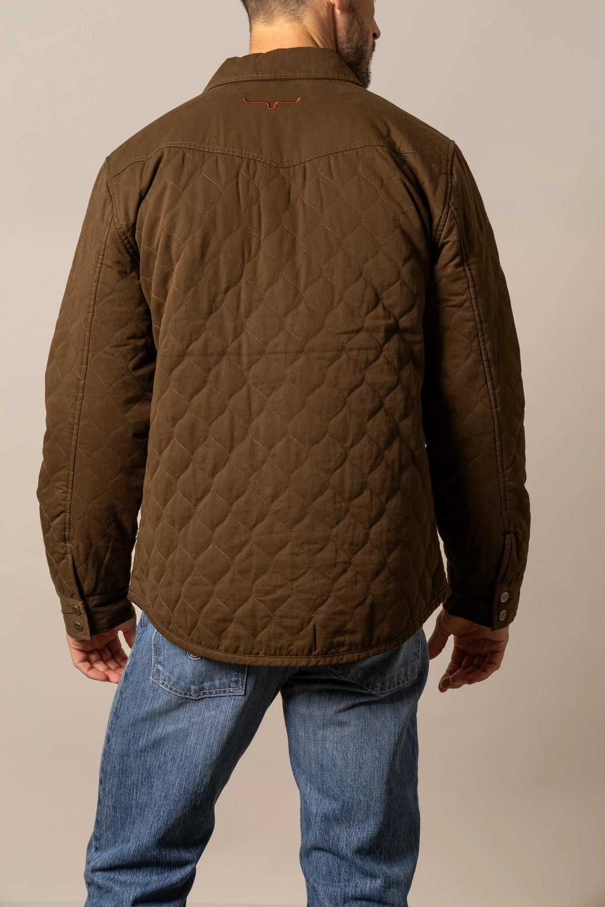 Kimes Ranch Dickson Shacket in Dark Brown, back view, with diamond quilting and a logo on the back yoke