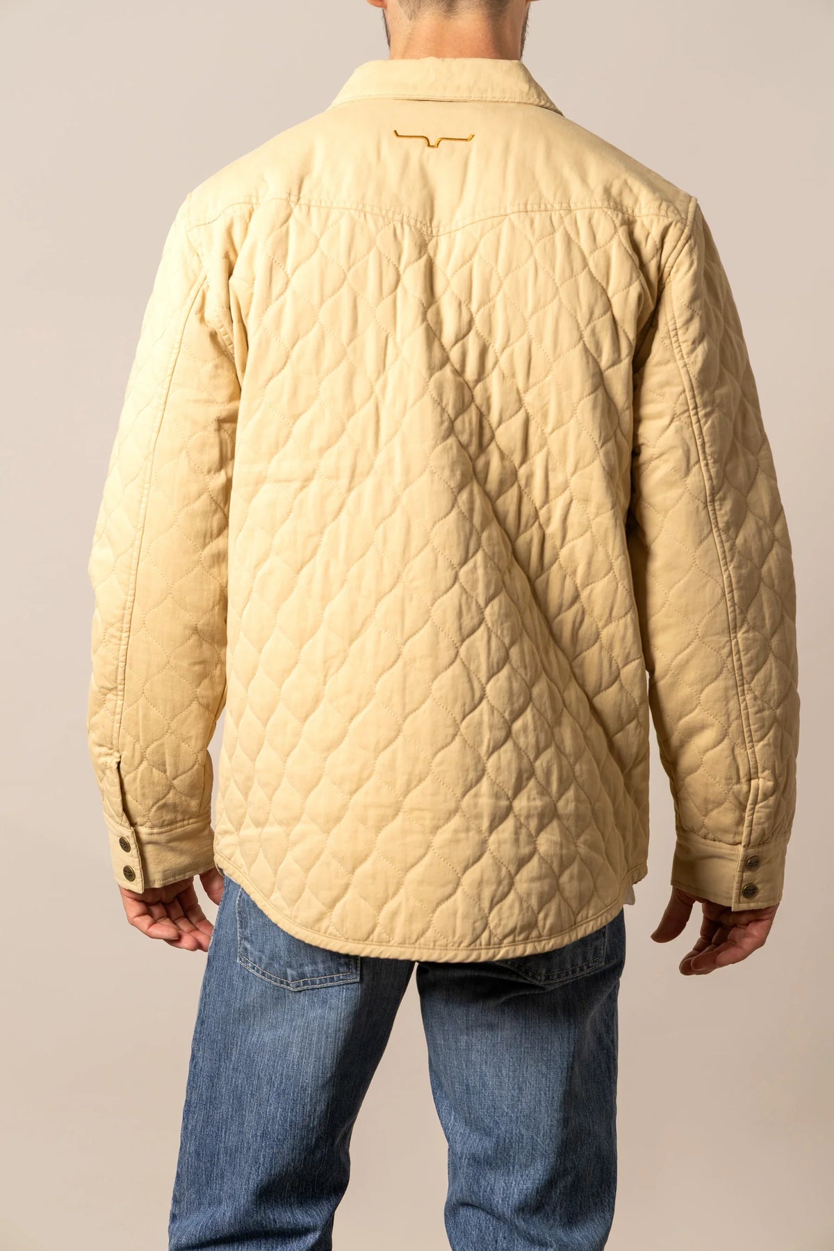 Kimes Ranch Dickson Shacket in Tan, back view, with diamond quilting and embroidered logo on the back yoke