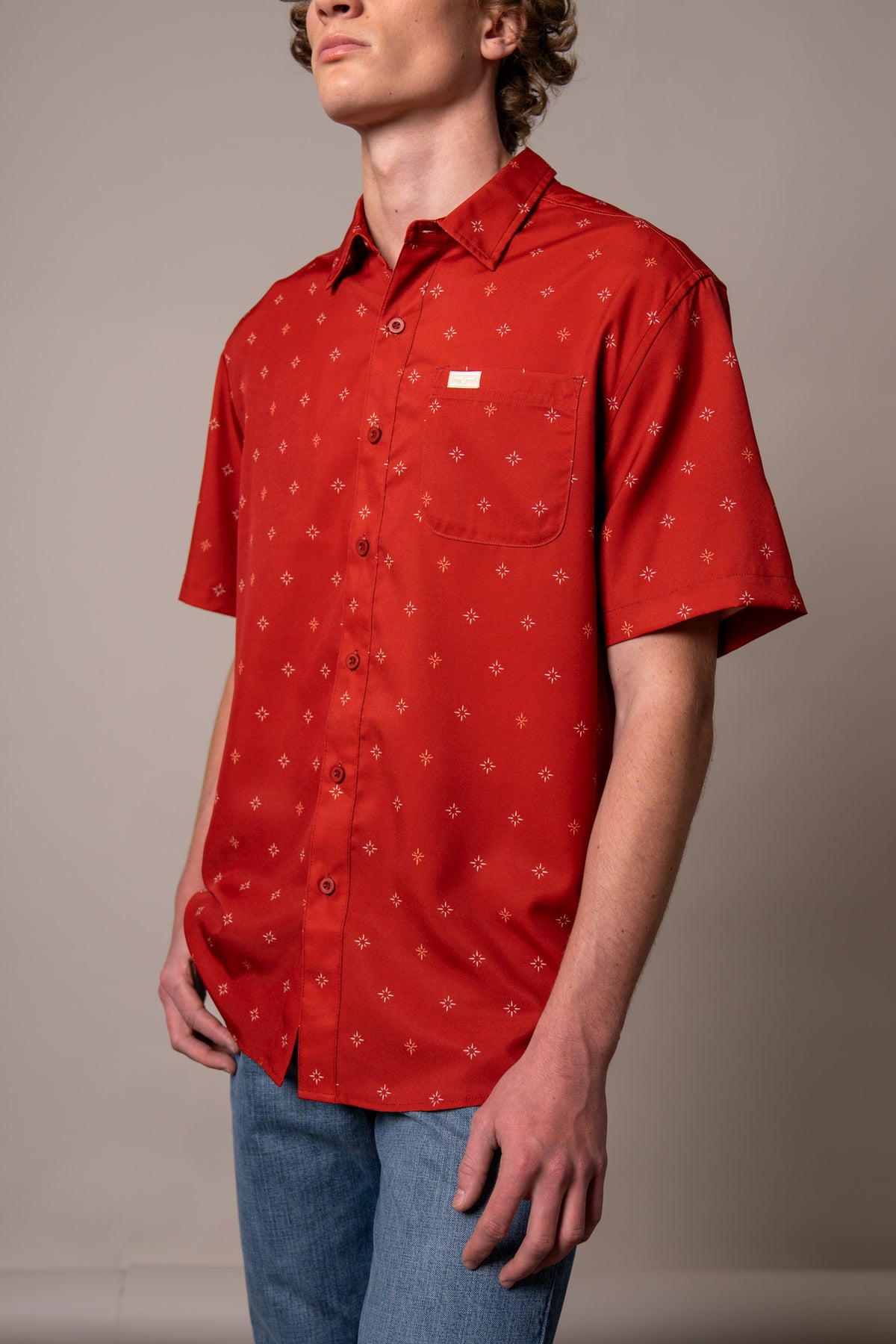 Kimes Ranch Dunn, side view, Red short sleeve dress shirt with a chest pocket and small white star print
