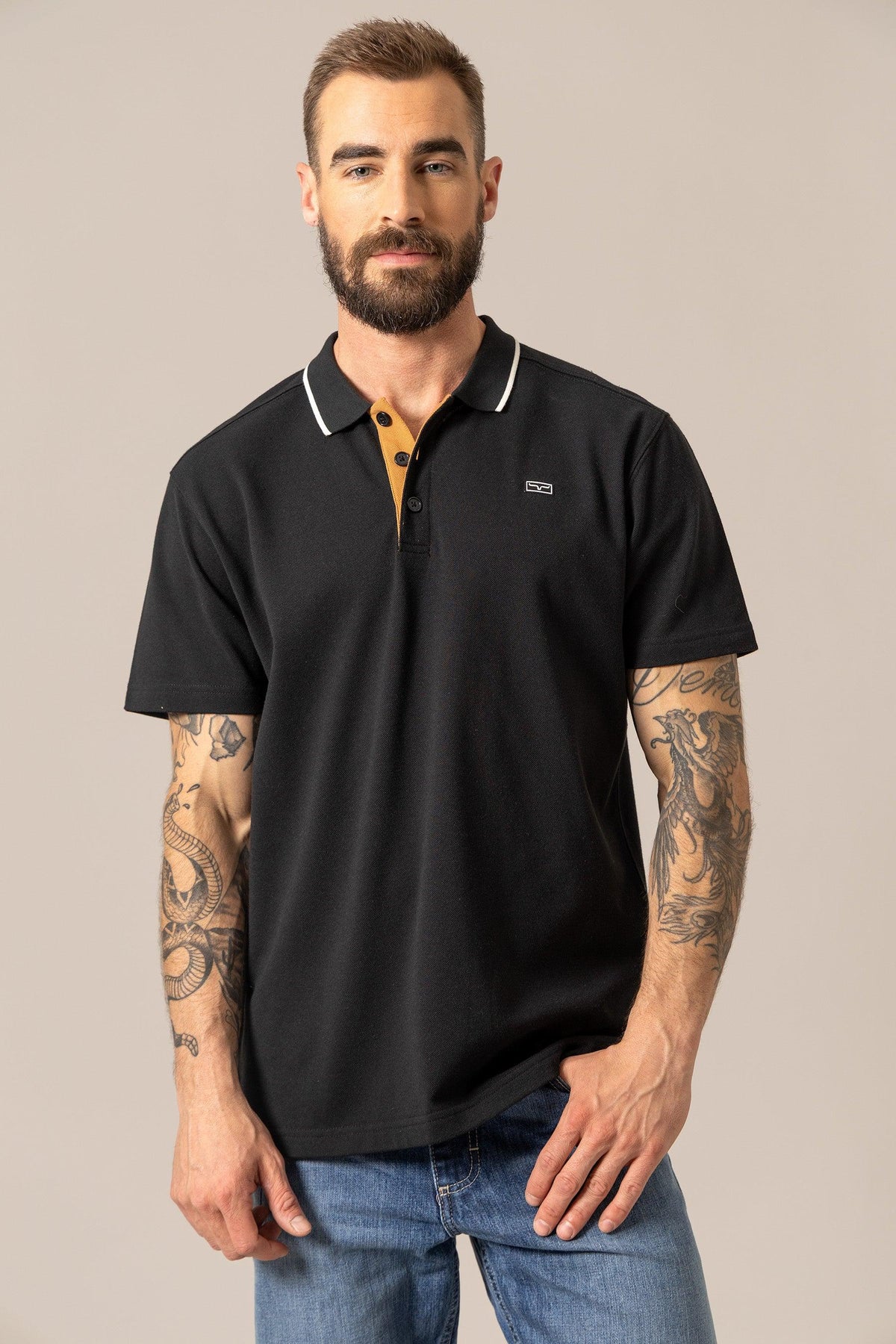 Kimes Ranch El Capitan Polo in Black with white collar trim and a mustard placket with a chest logo