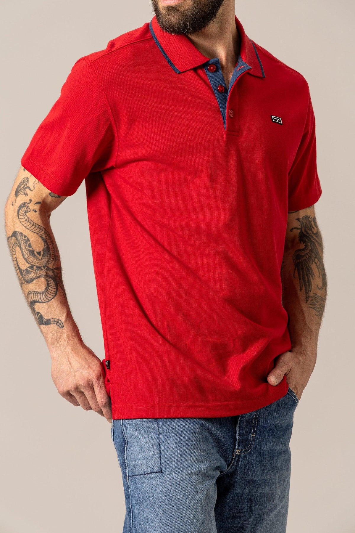 Kimes Ranch El Capitan Polo in Red with a blue collar and placket and the Kimes Ranch logo on the chest