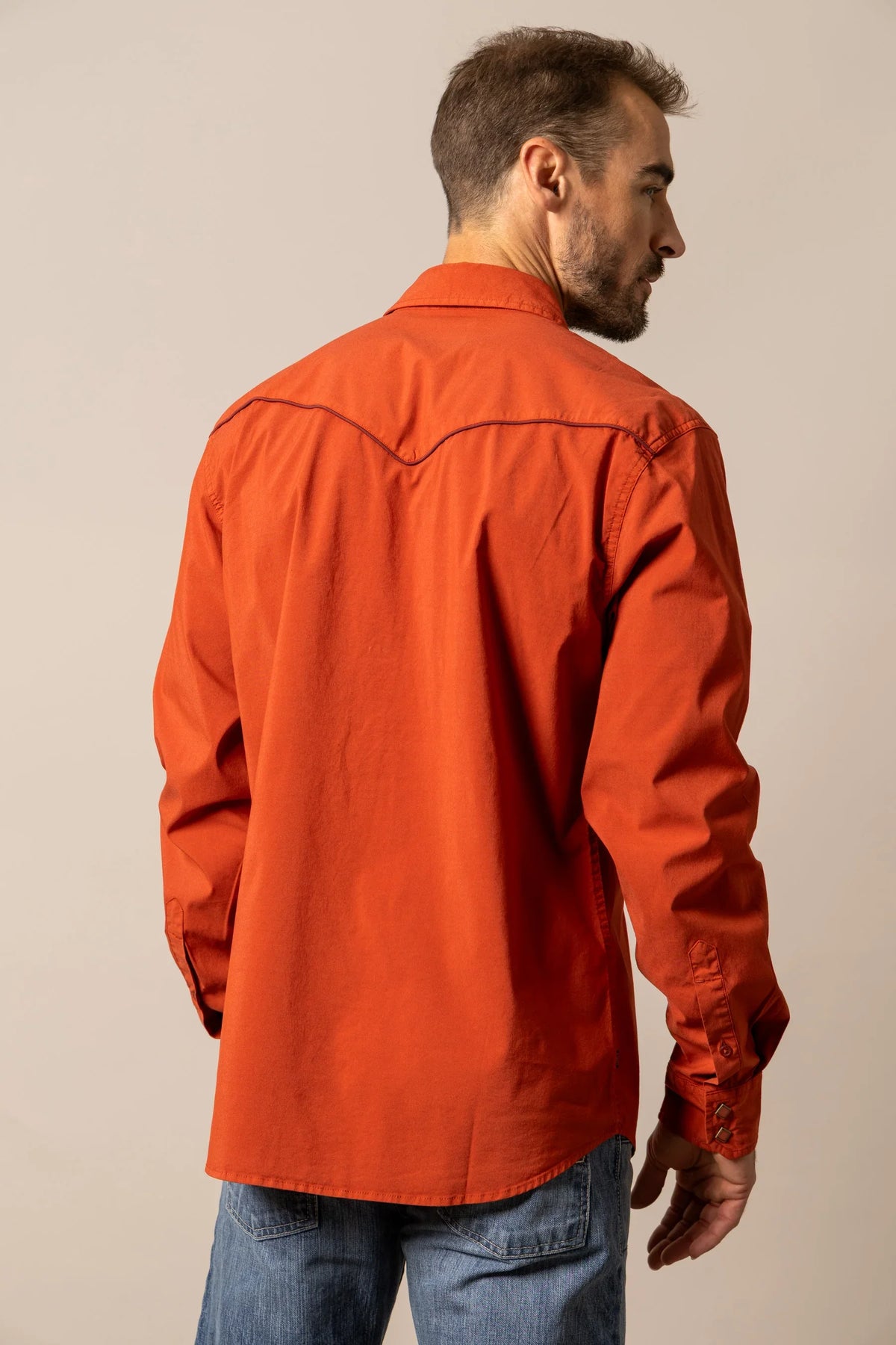 Kimes Ranch El Toro dress shirt in Brick Red, back view, with contrast stitching on the back yoke and button cuffs