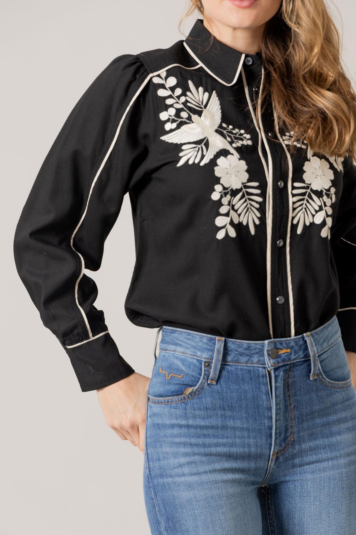 Kimes Ranch Emilia Tencel top in Black with white embroidery of a bird and floral design with contrast piping