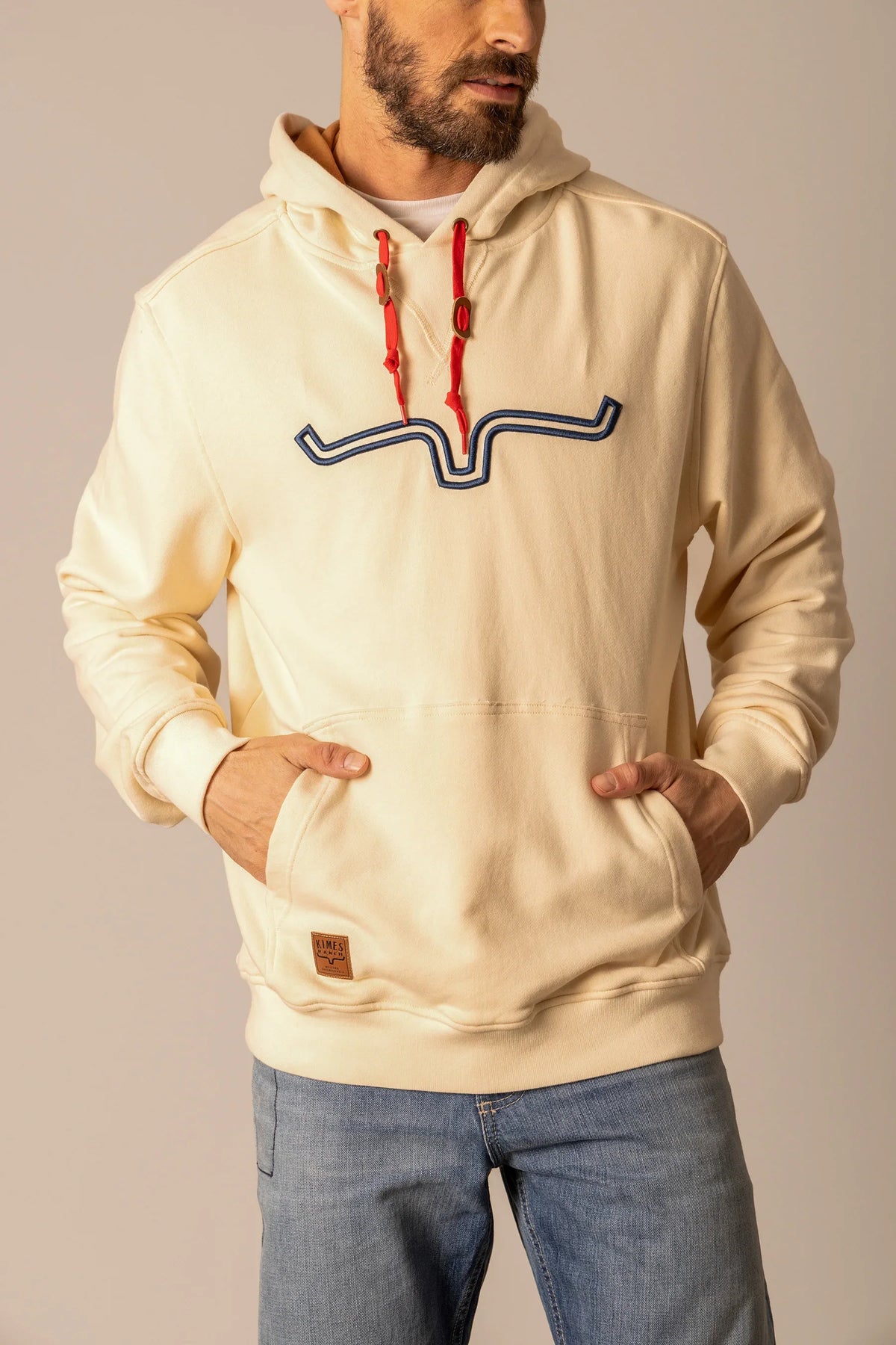 Kimes Ranch Fast Talker Hoodie in Natural with red drawstrings and a blue embroidered logo on the chest