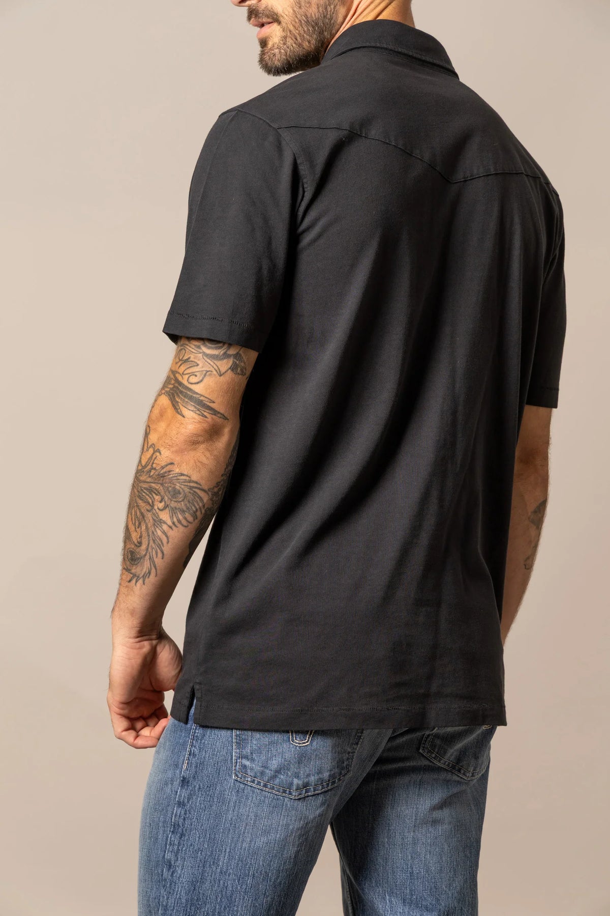 Kimes Ranch Fluger Polo in Black, back view, with a back yoke and short sleeves