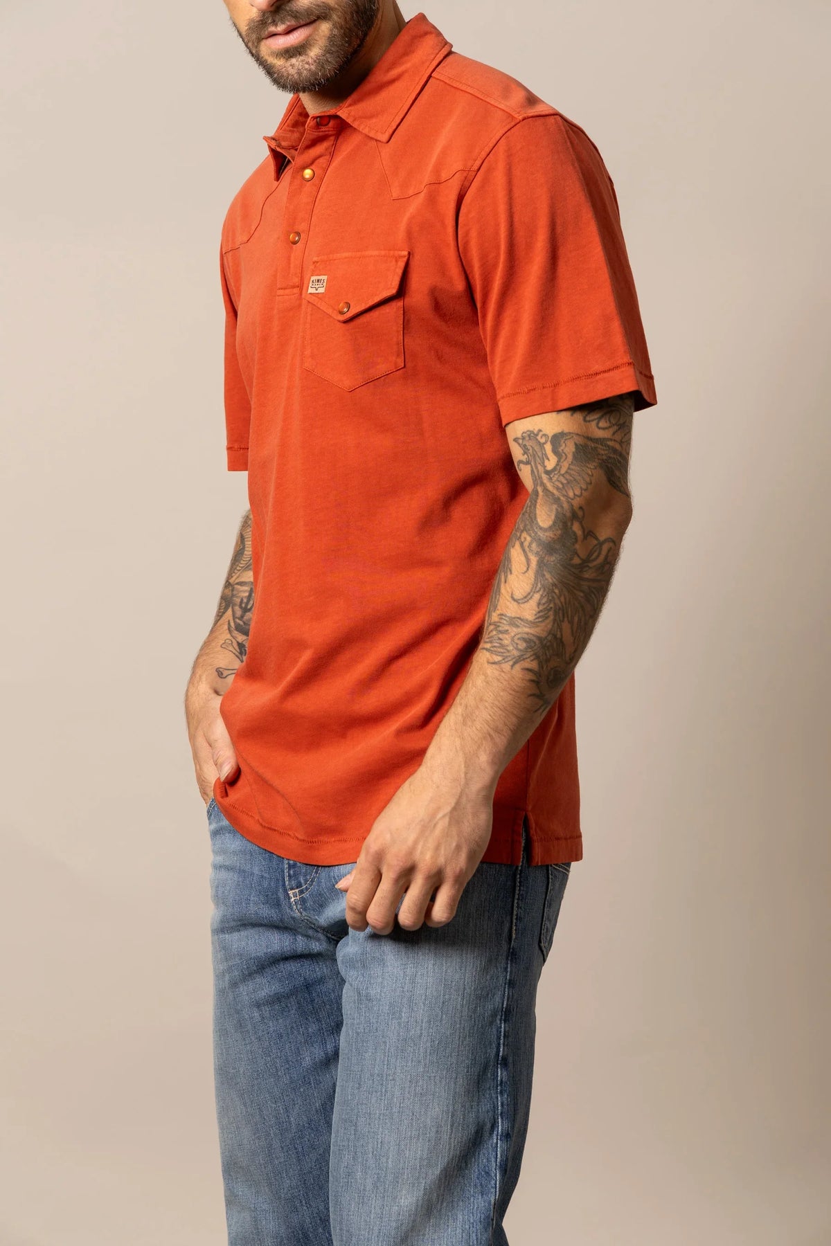 Kimes Ranch Fluger Polo in Brick Red, side view, with a chest pocket and short sleeves