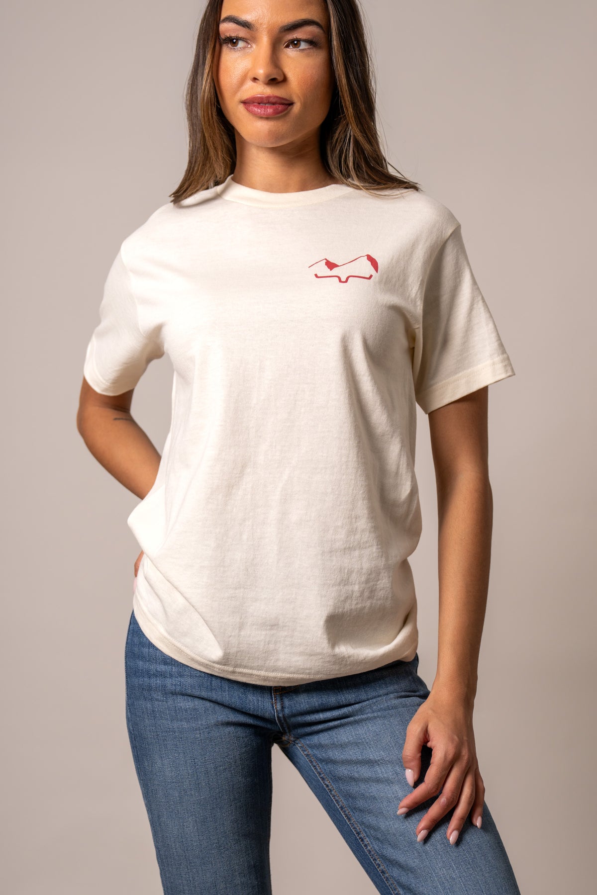 Kimes Ranch Flying High Cream shirt with short sleeves and a red logo on the chest