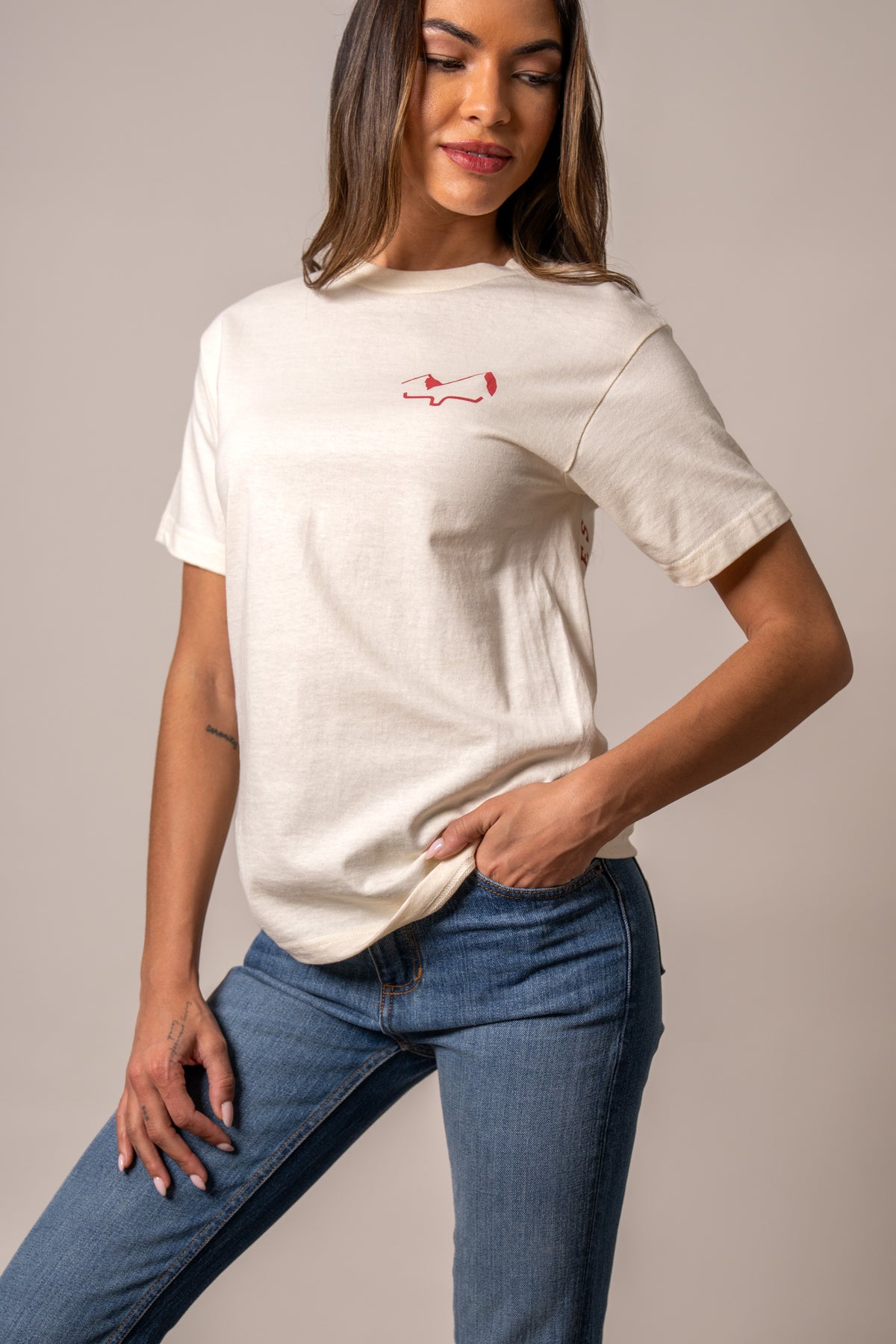 Kimes Ranch Flying High Cream short sleeve shirt with red logo on the chest