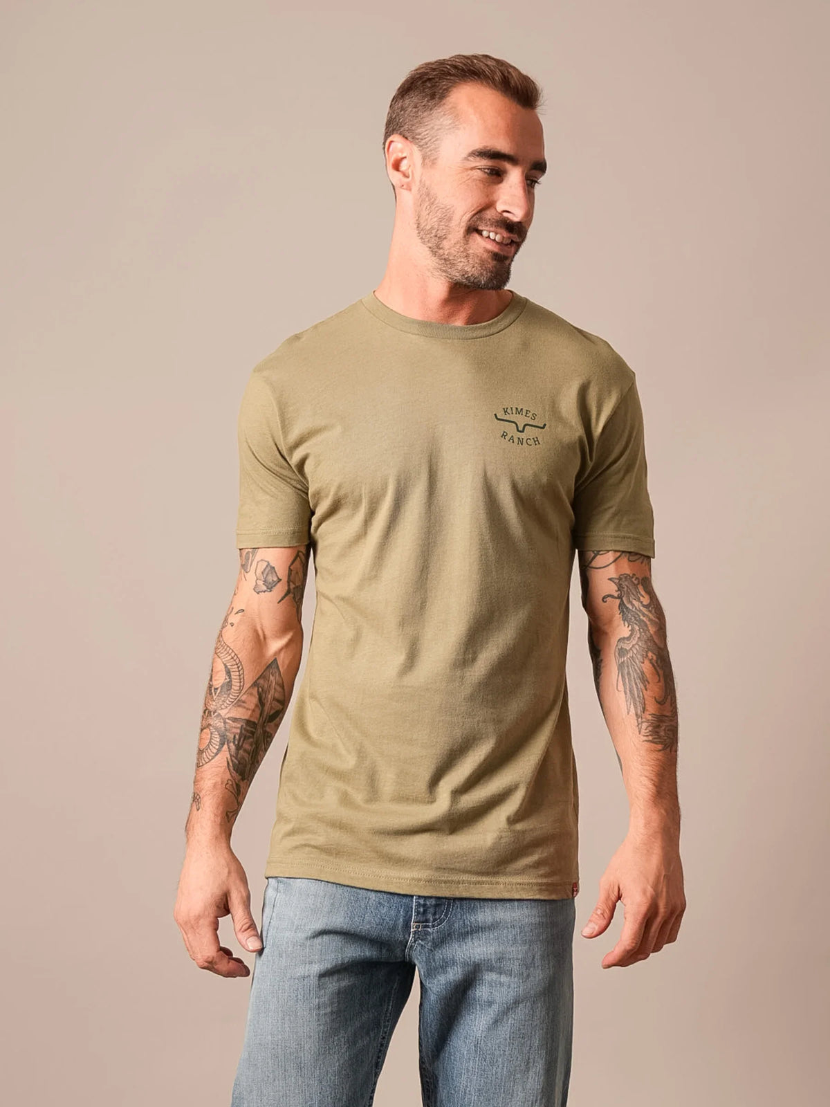 Kimes Ranch Flying High shirt in Light Olive with short sleeves and a crew neck featuring the Kimes Ranch logo on the chest
