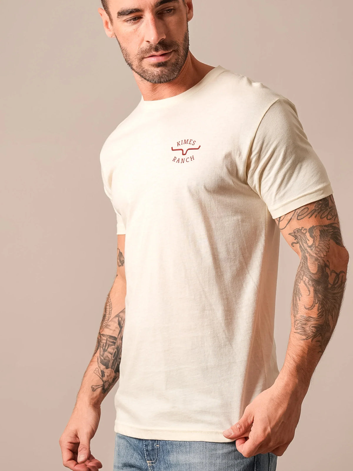 Kimes Ranch Flying High short sleeve shirt in Natural, side view, with the Kimes Ranch logo on the chest