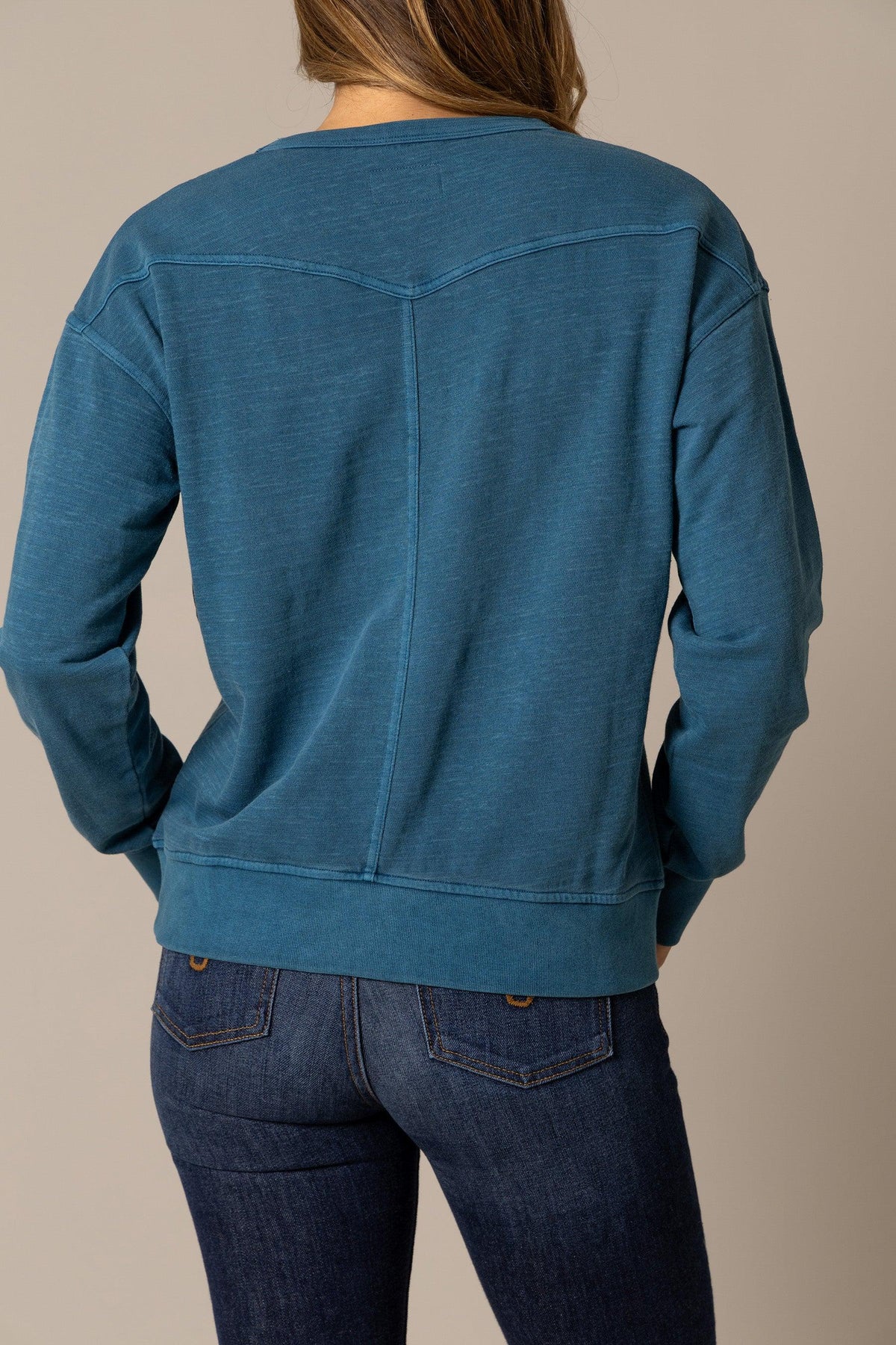 Kimes Ranch Gina Western Crew sweatshirt in Mid Blue, back view, with a back yoke and long sleeves