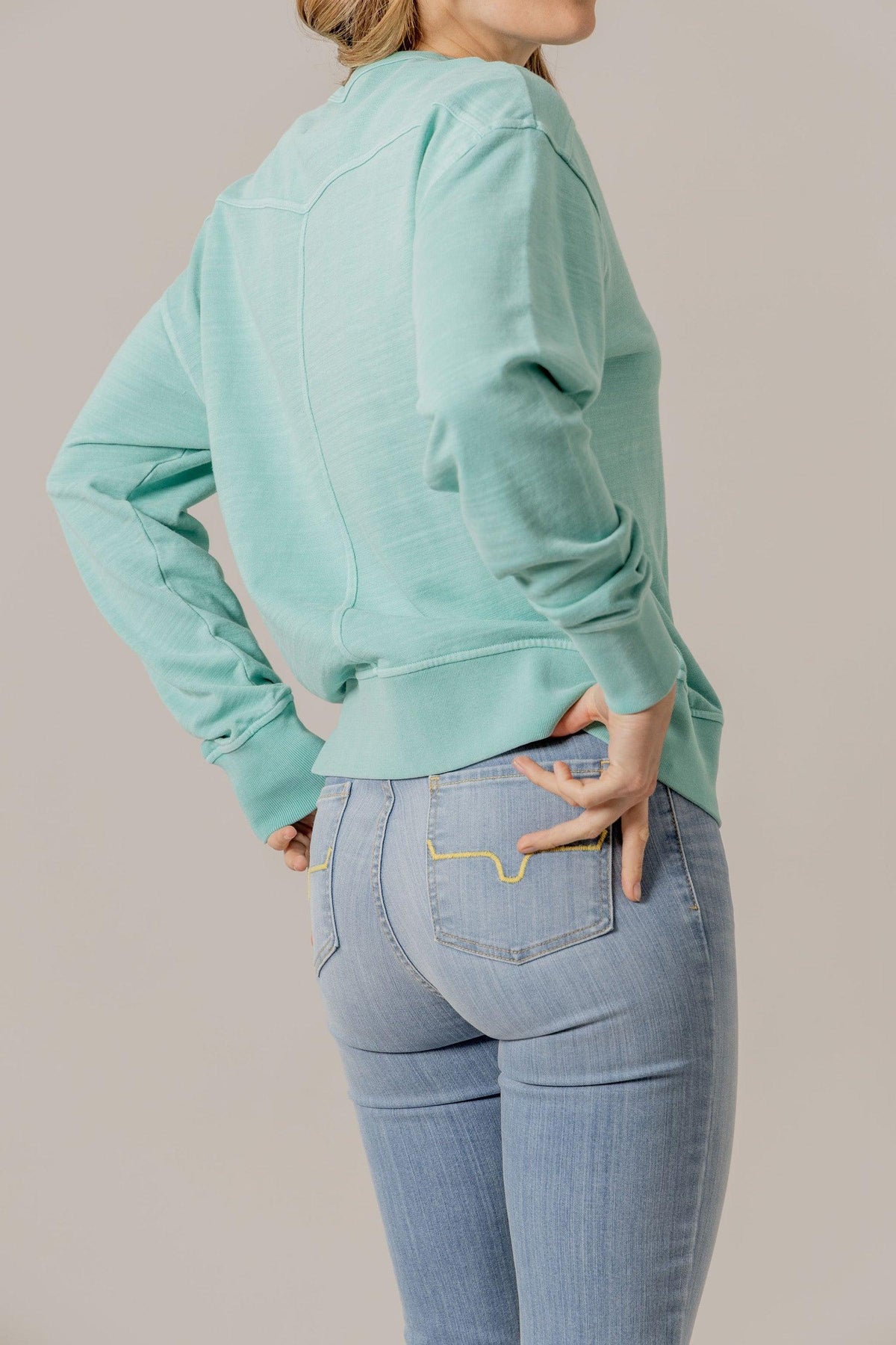 Kimes Ranch Gina Western Crew sweatshirt in Turquoise, side view, with long sleeves and ribbed cuffs