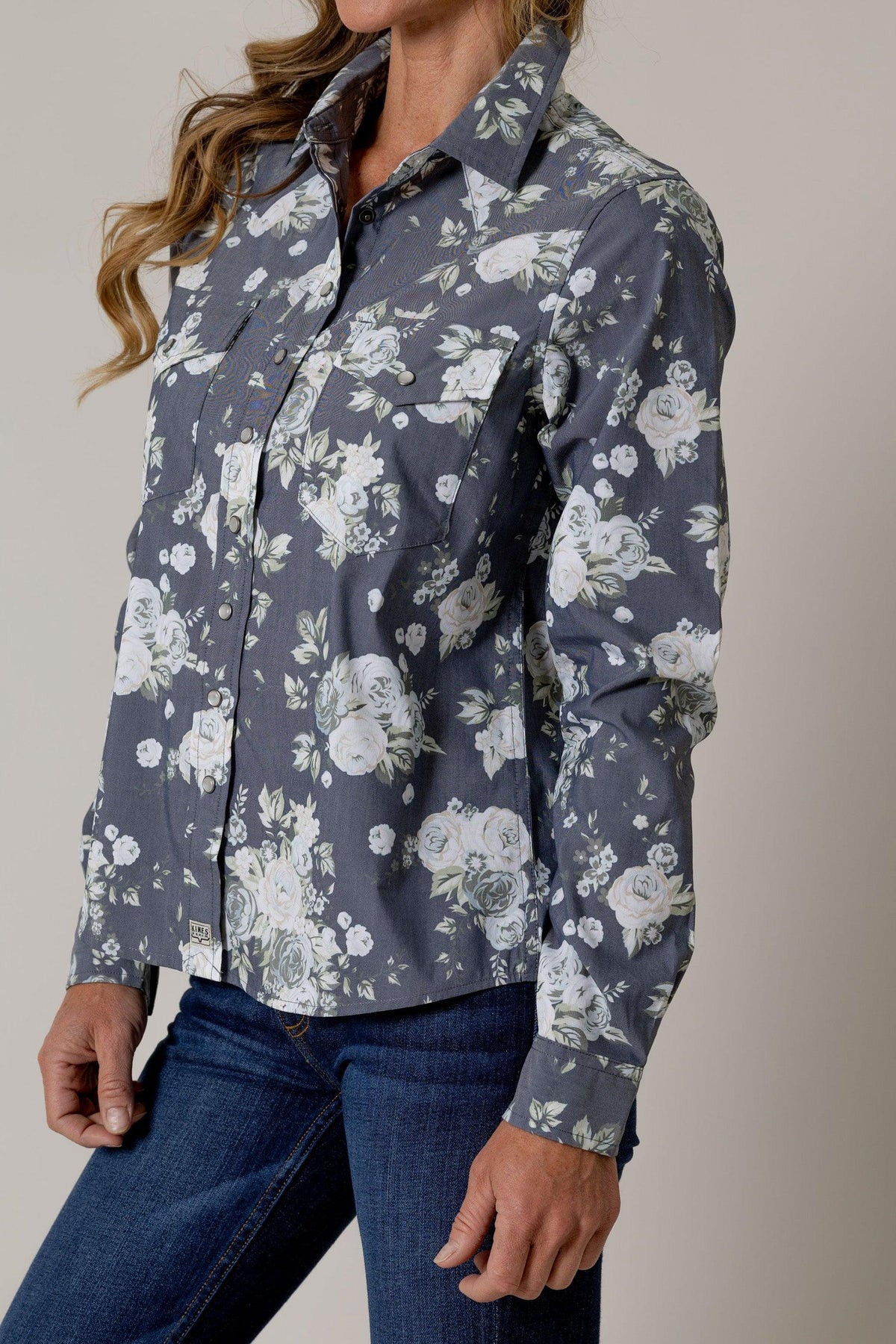 Kimes Ranch Ginny Snap top in Blue, side view, with a white floral print and two chest pockets