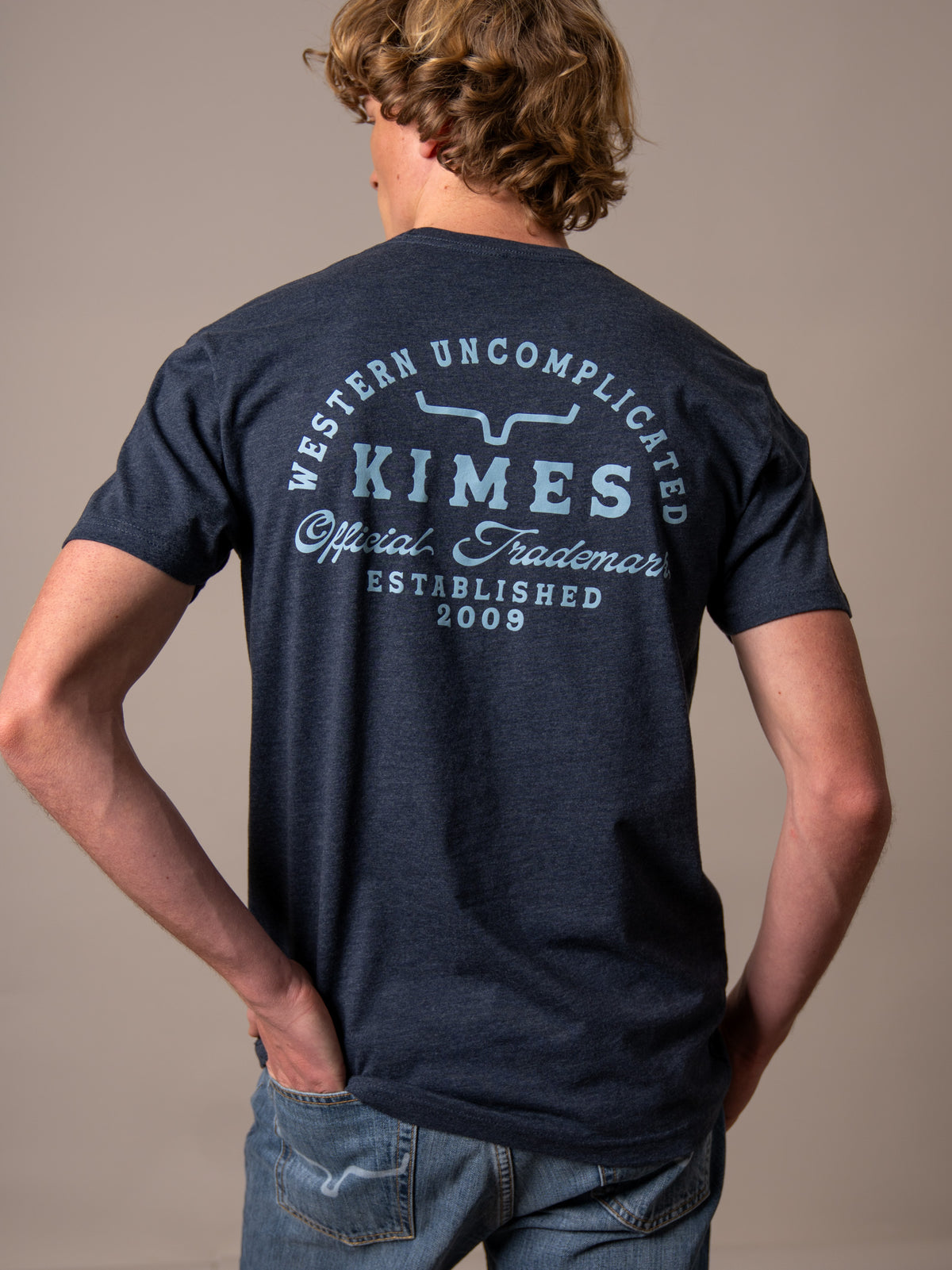 Kimes Ranch Heavy Text shirt in Midnight Navy, back view, with back graphic reading Western Uncomplicated Kimes Official
