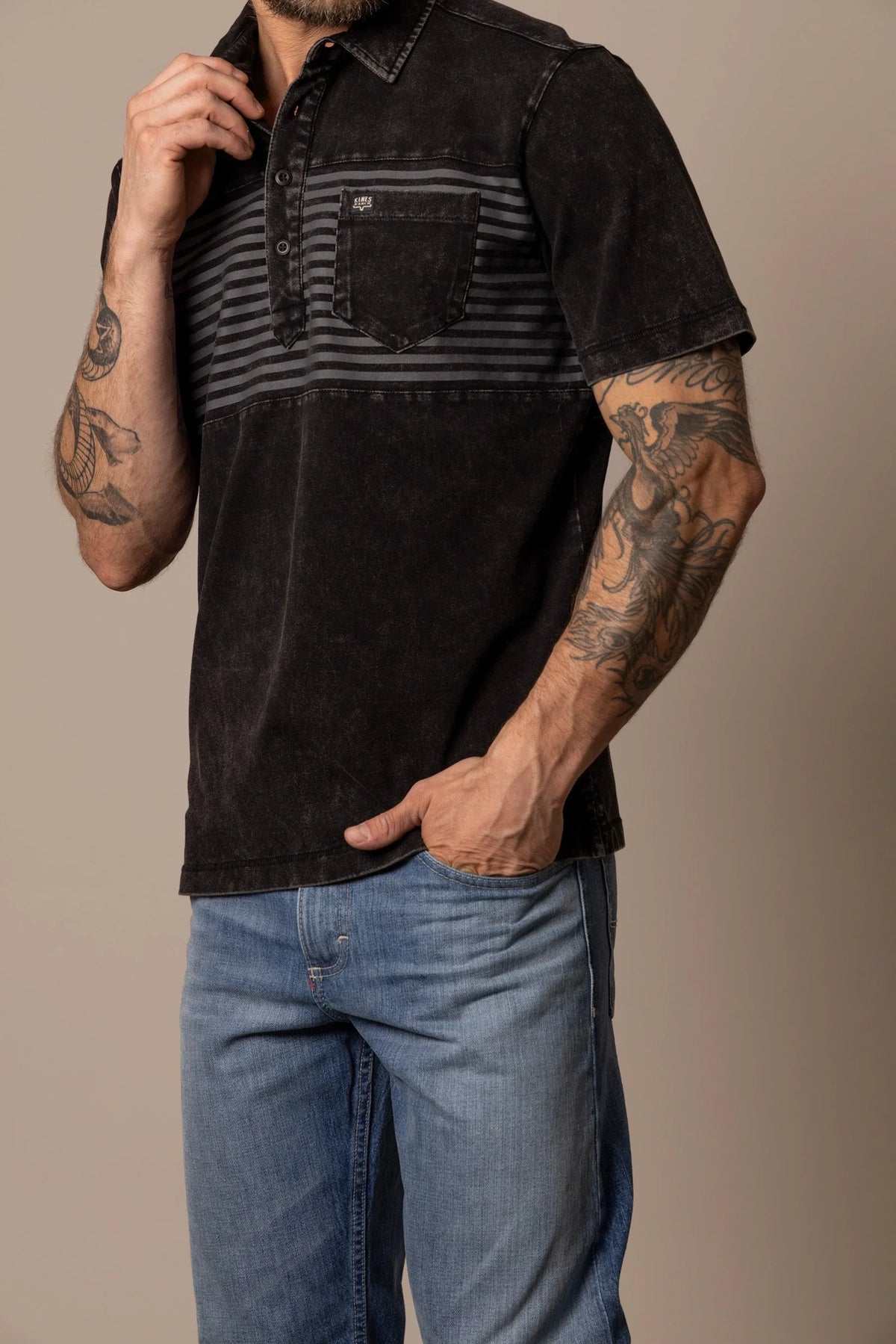 Kimes Ranch Holbrook Polo in Black with a striped chest panel and a front pocket