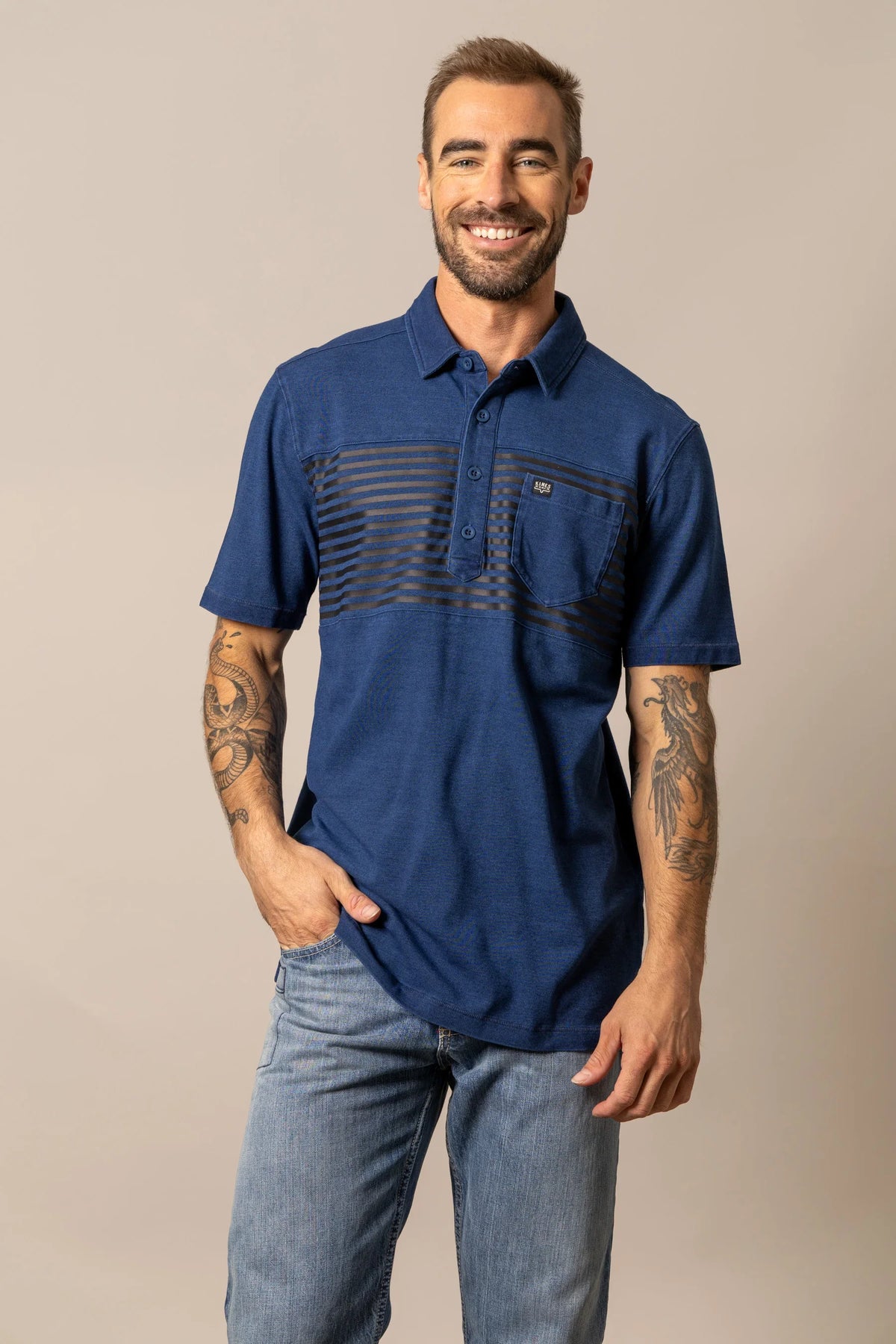 Kimes Ranch Holbrook Polo in Indigo with horizontal stripes across the chest and a chest pocket with the Kimes Ranch logo