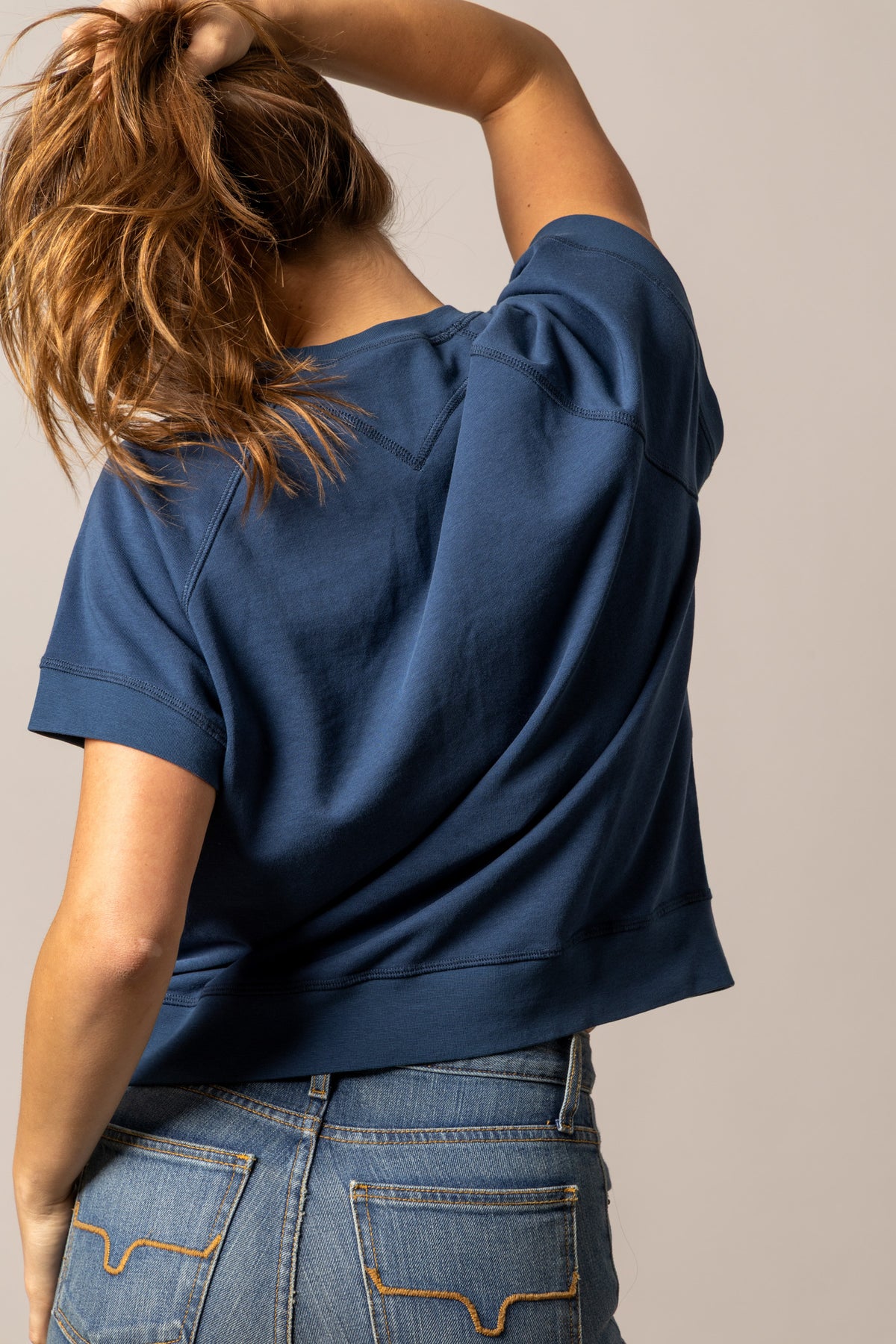 Kimes Ranch Holly sweatshirt in Dark Blue, back view, with a cropped back hem and short sleeves