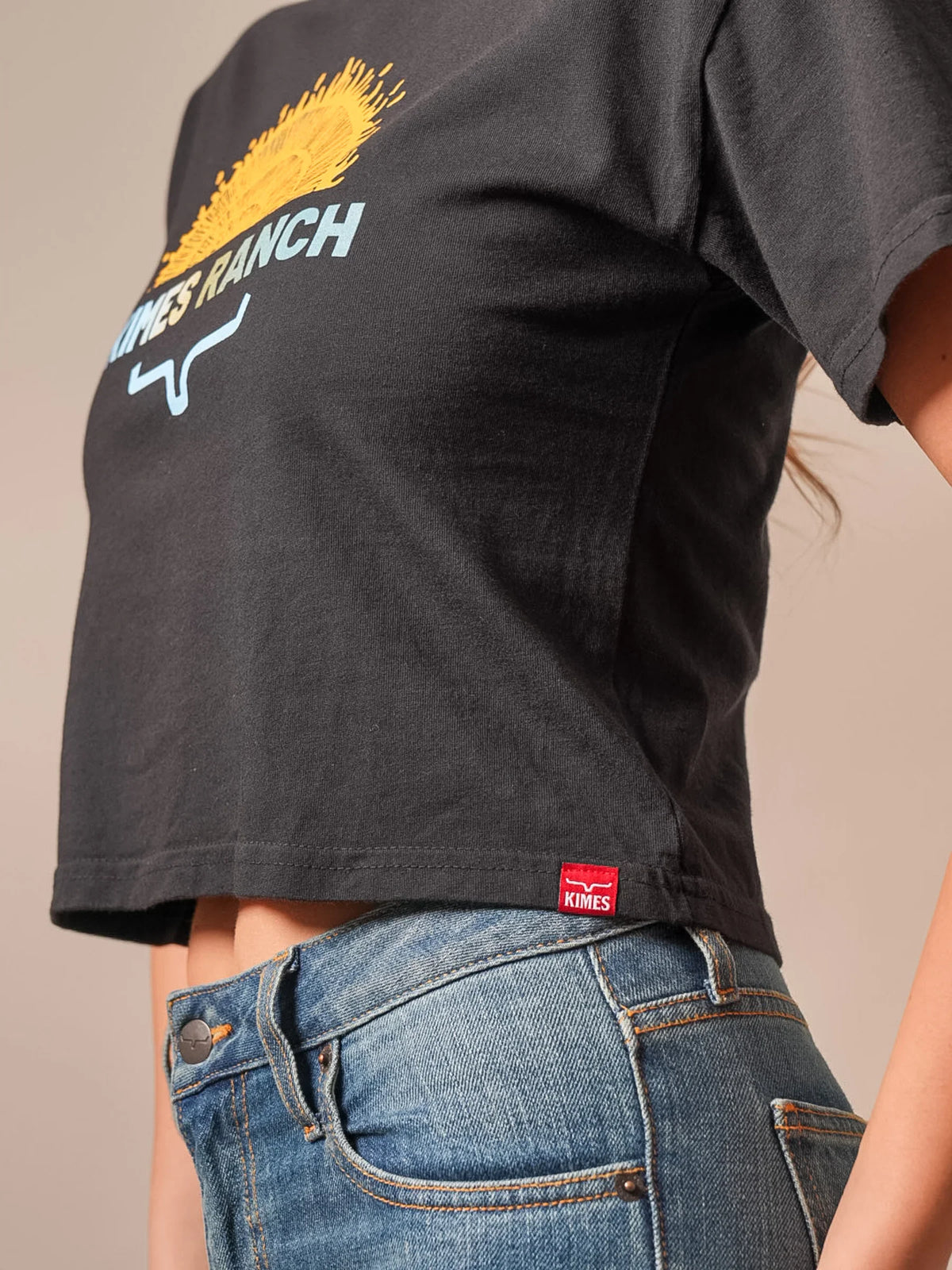 Kimes Ranch Home Grown, back view, Black short sleeve shirt with a sun graphic and logo on the back