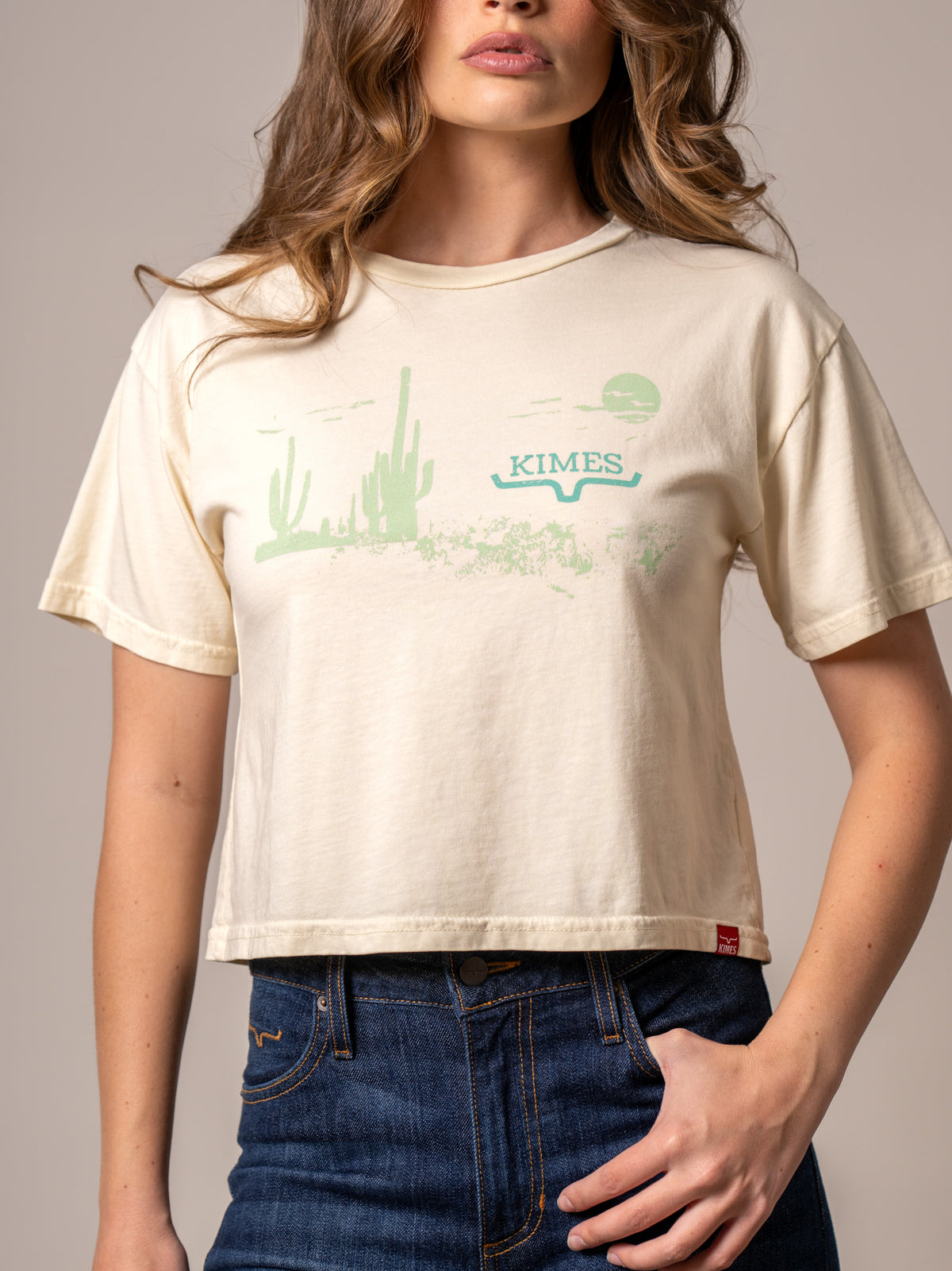 Kimes Ranch Horizon West shirt in Ivory with a green cactus landscape graphic and KIMES wordmark