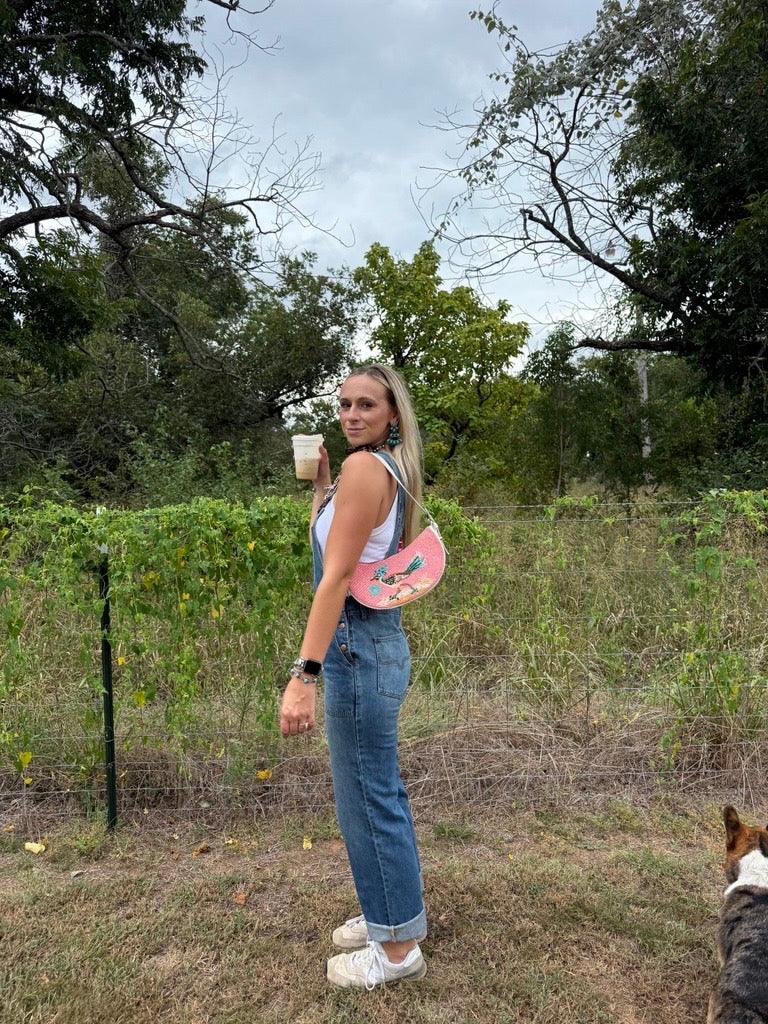 Kimes Ranch Billy Overalls, side view, in blue with a button front and rolled cuffs