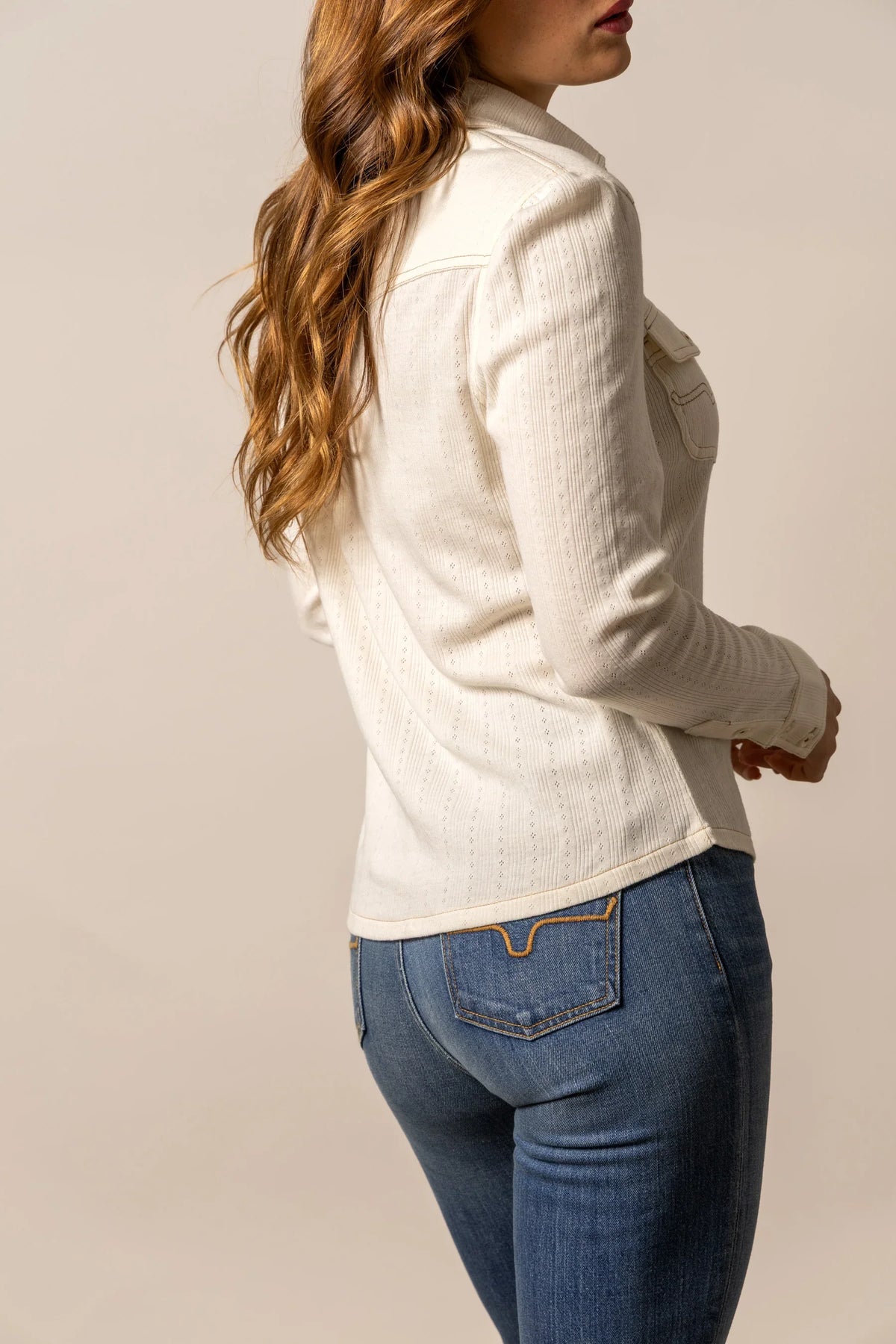 Kimes Ranch Isabel Pointelle top in Pristine, side view, with long sleeves and a pointelle knit texture