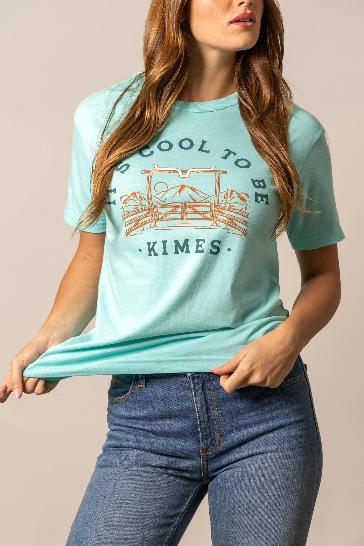 Kimes Ranch It's Cool to be Kimes shirt in Light Blue with a gate and mountains graphic and text