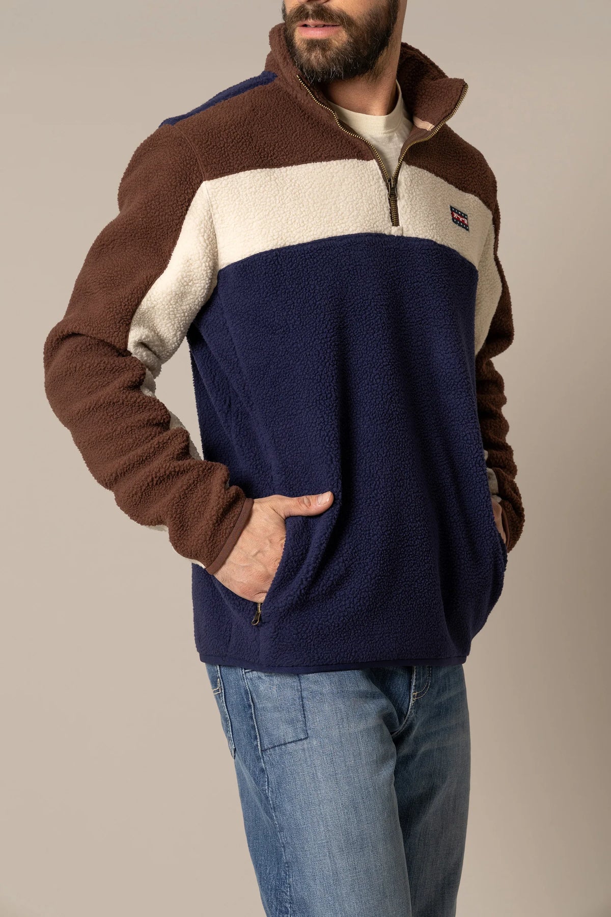 Kimes Ranch JMJ Quarter Zip sweatshirt in Navy, side view, with brown and cream colorblocking and zippered pockets