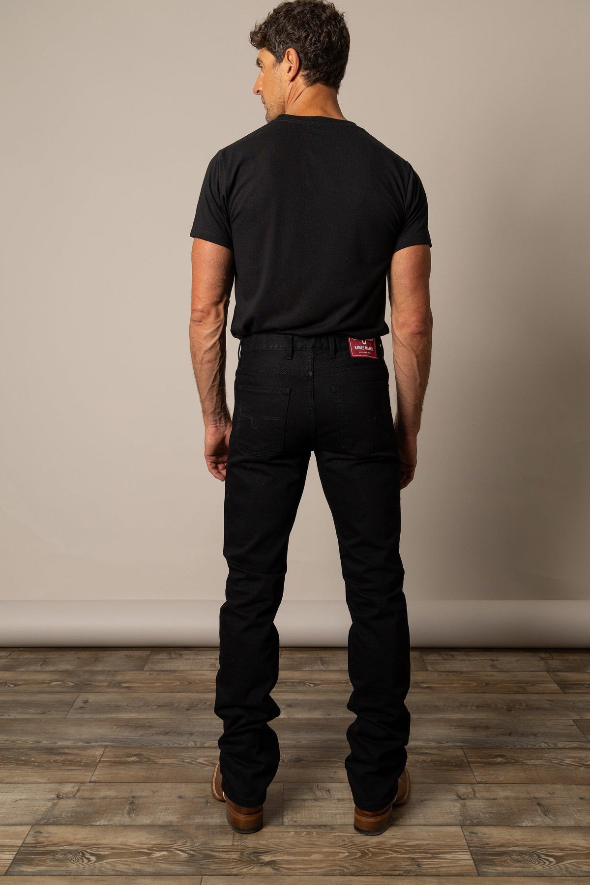 Kimes Ranch James Straight Fit Bootcut jeans in Black, back view, with back pockets and a red logo patch