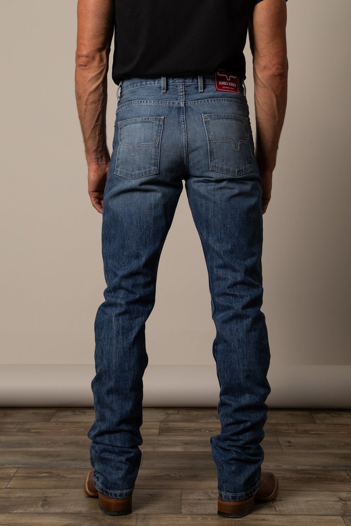 Kimes Ranch James Straight Fit Bootcut jeans in Mid Wash, back view, with signature back pocket stitching and logo patch