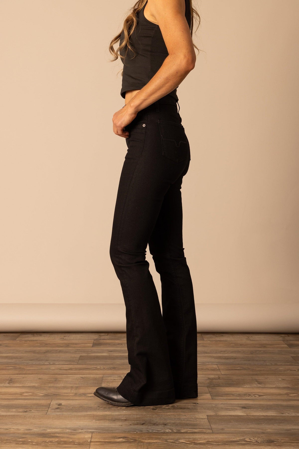 Kimes Ranch Jennifer jeans in Black, side view, with a flared leg and back pockets