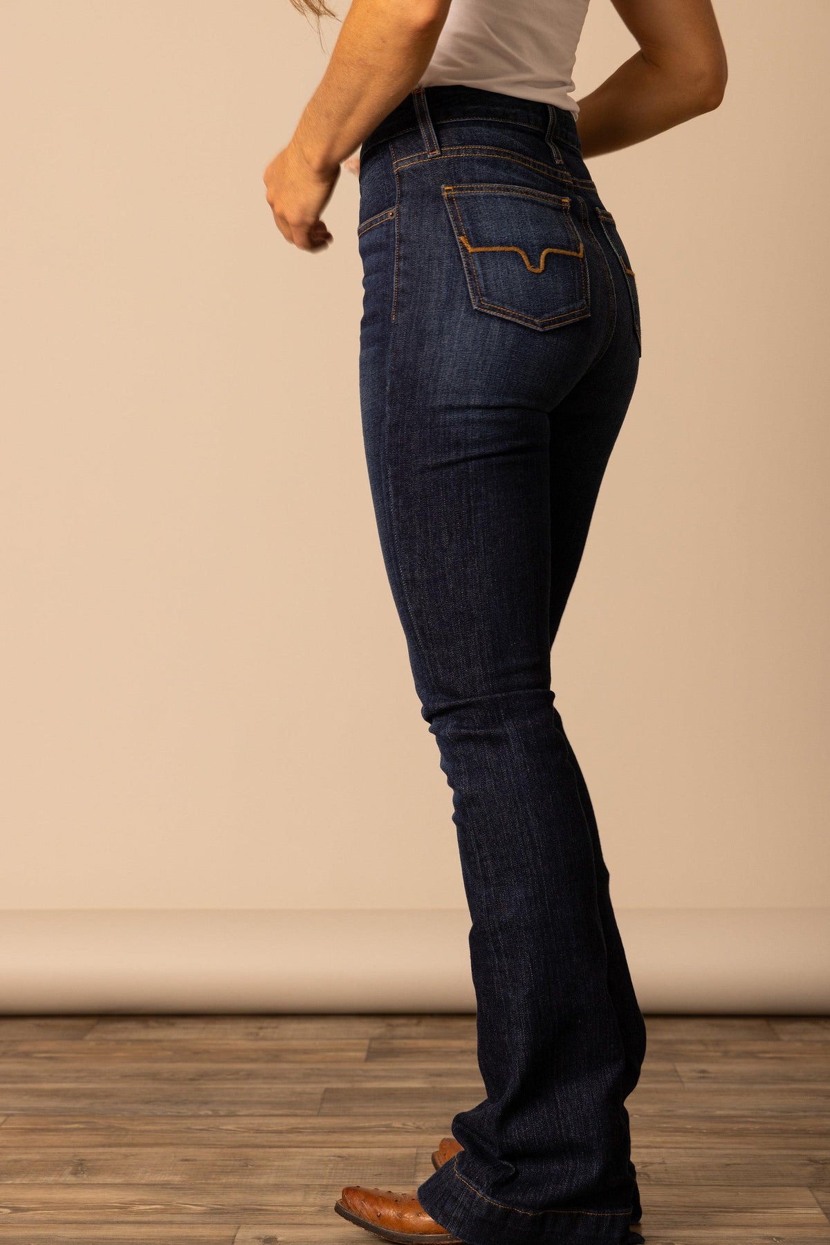 Kimes Ranch Jennifer jeans in Dark Wash, side view, with the flared leg and back pocket detail