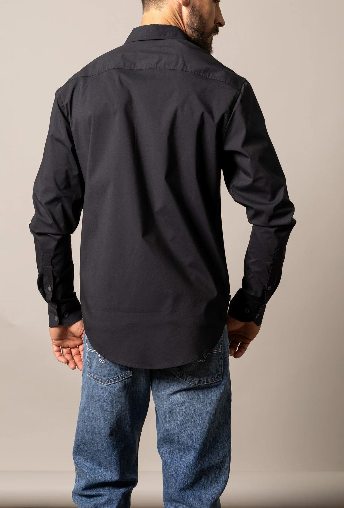 Kimes Ranch KR Team Dress Shirt in Black, back view, with a back yoke and button cuffs