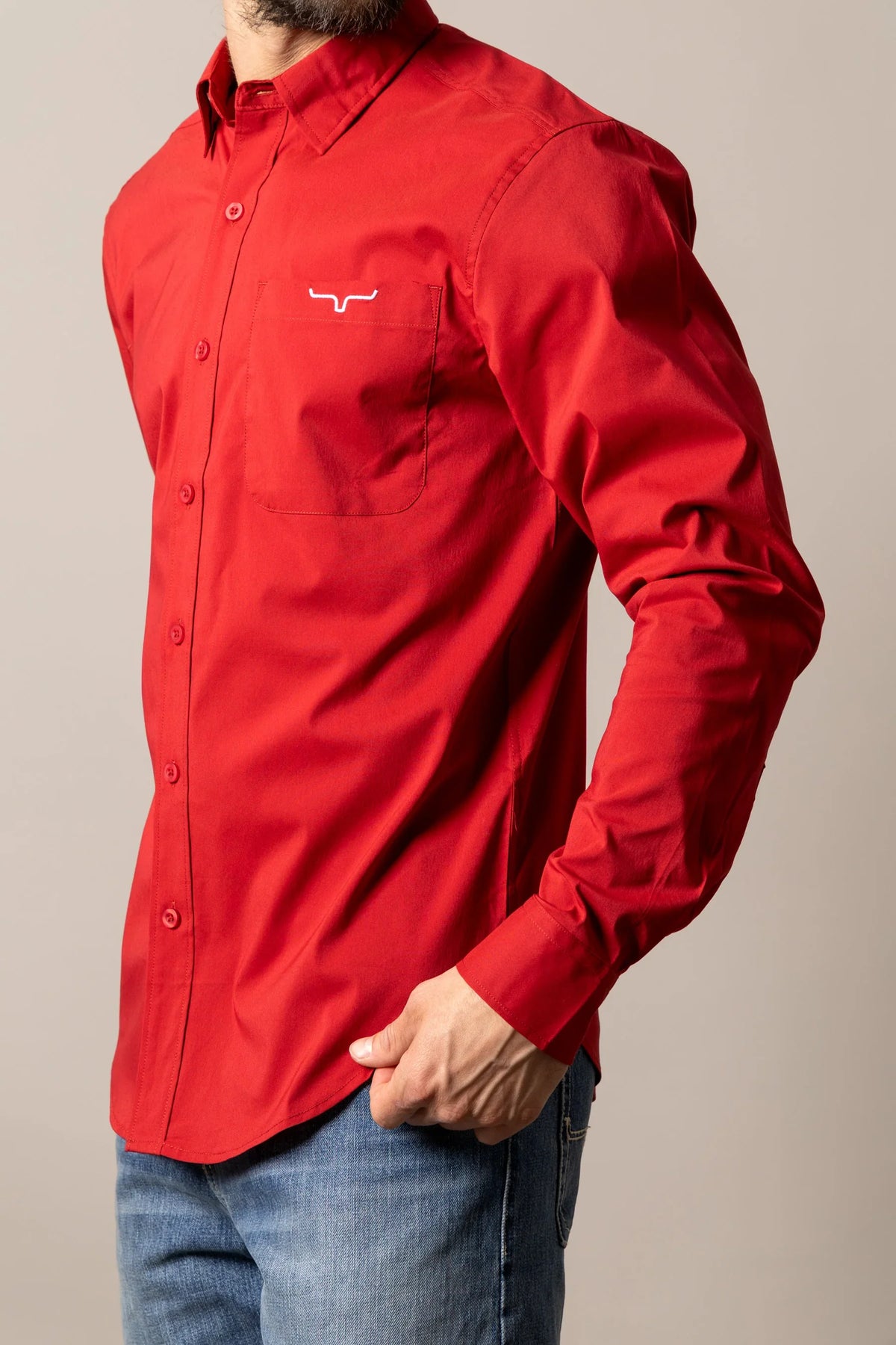 Kimes Ranch KR Team Dress Shirt in Red, side view, with long sleeves and a chest pocket featuring the Kimes Ranch logo