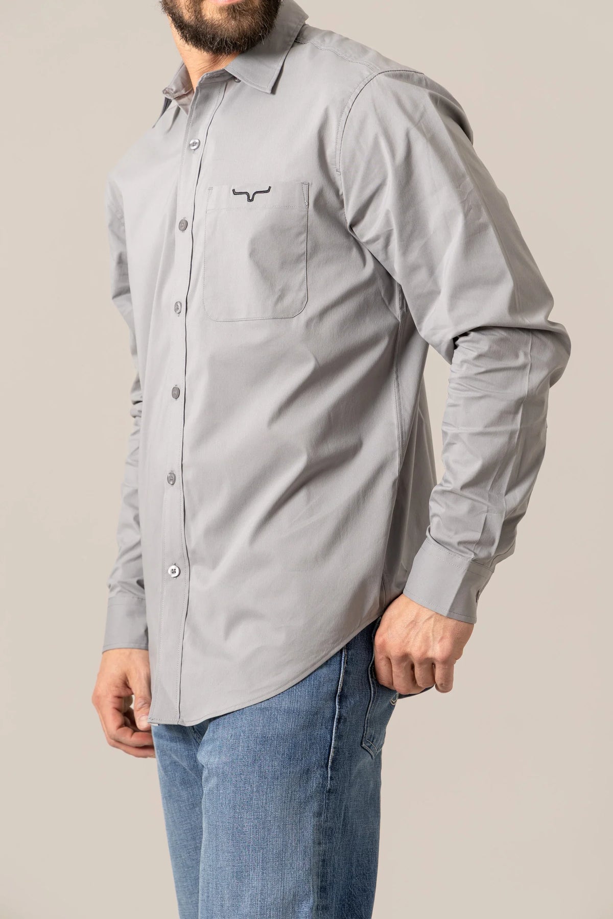 Kimes Ranch KR Team Dress Shirt in Grey, side view, with long sleeves and a chest pocket featuring the Kimes Ranch logo