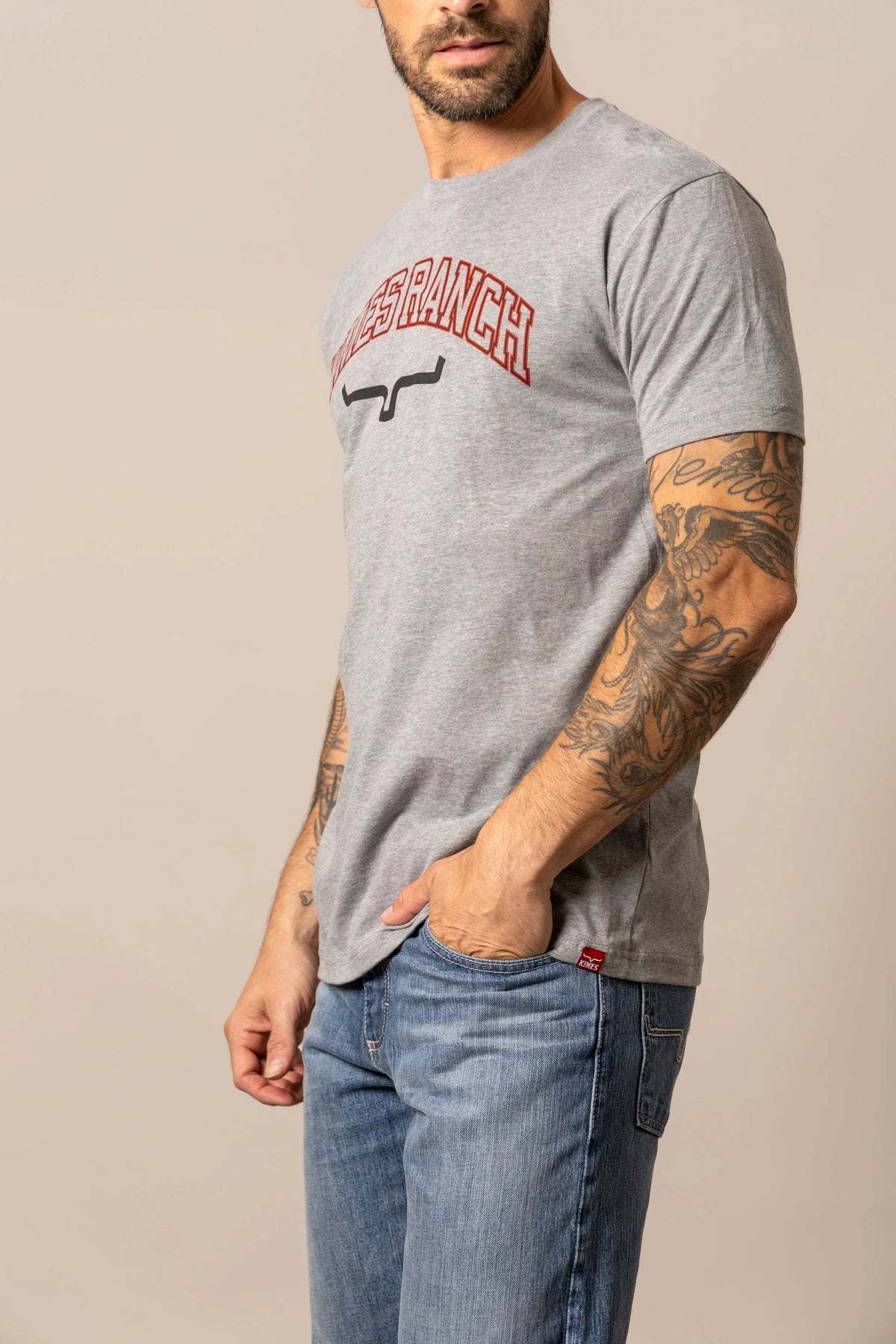 Kimes Ranch KR University shirt in Grey Heather, side view, with a front graphic featuring the brand name and logo