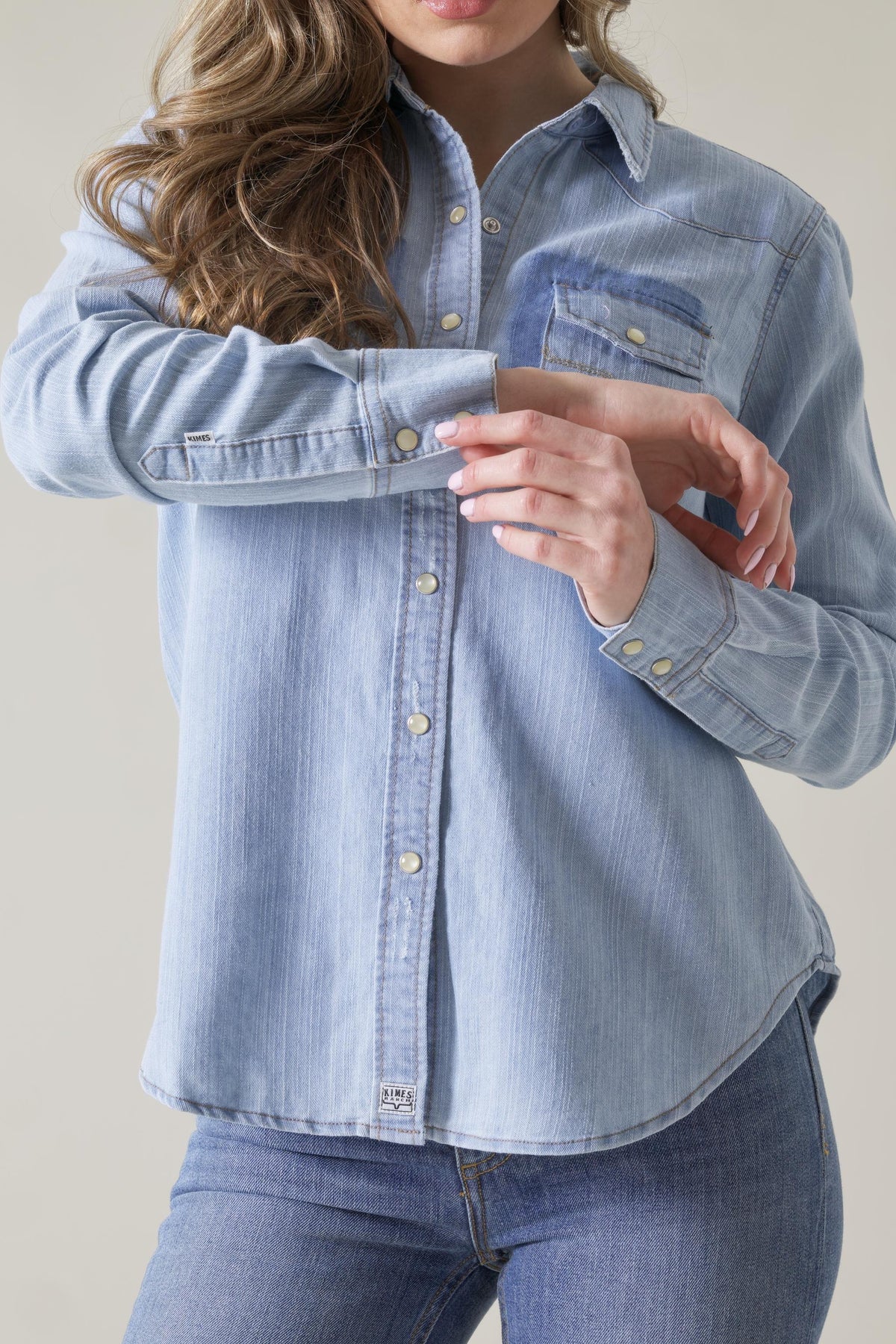 Kimes Ranch Kaycee Denim Top in light blue with a button front, chest pockets, and a collar