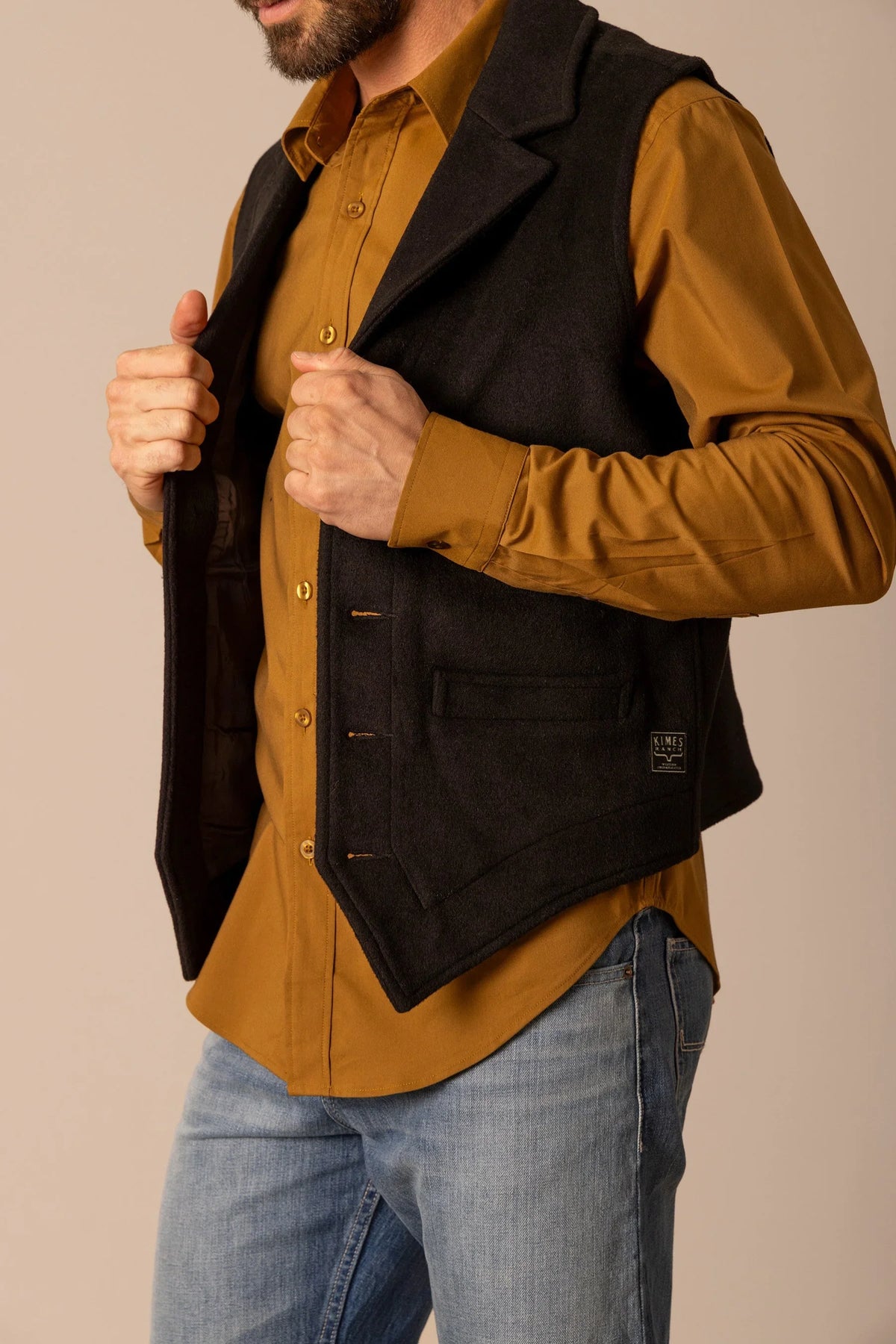 Kimes Ranch Kraken Vest in Black, side view, with a front pocket and logo patch