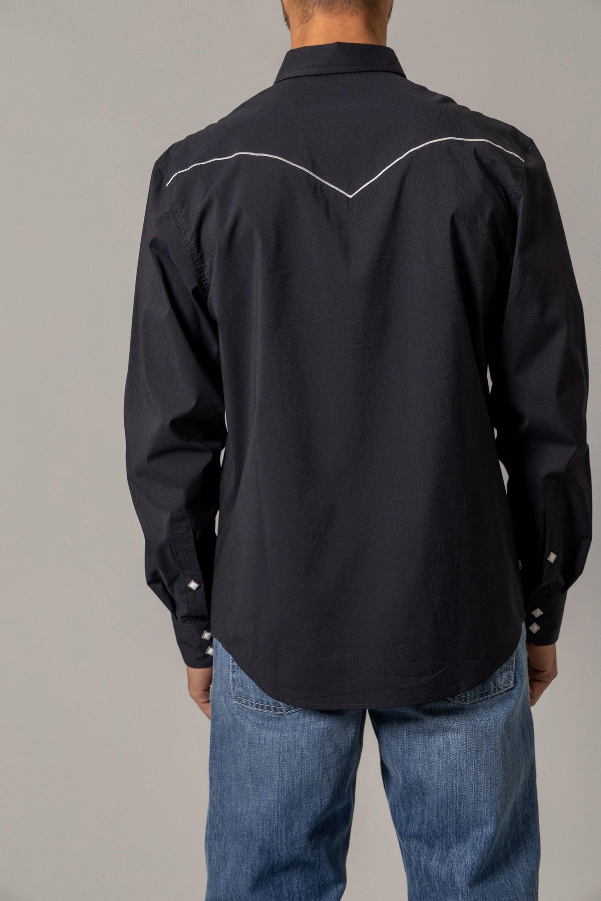 Kimes Ranch Laneboro, back view, Black dress shirt with white contrast stitching on the back yoke and cuffs