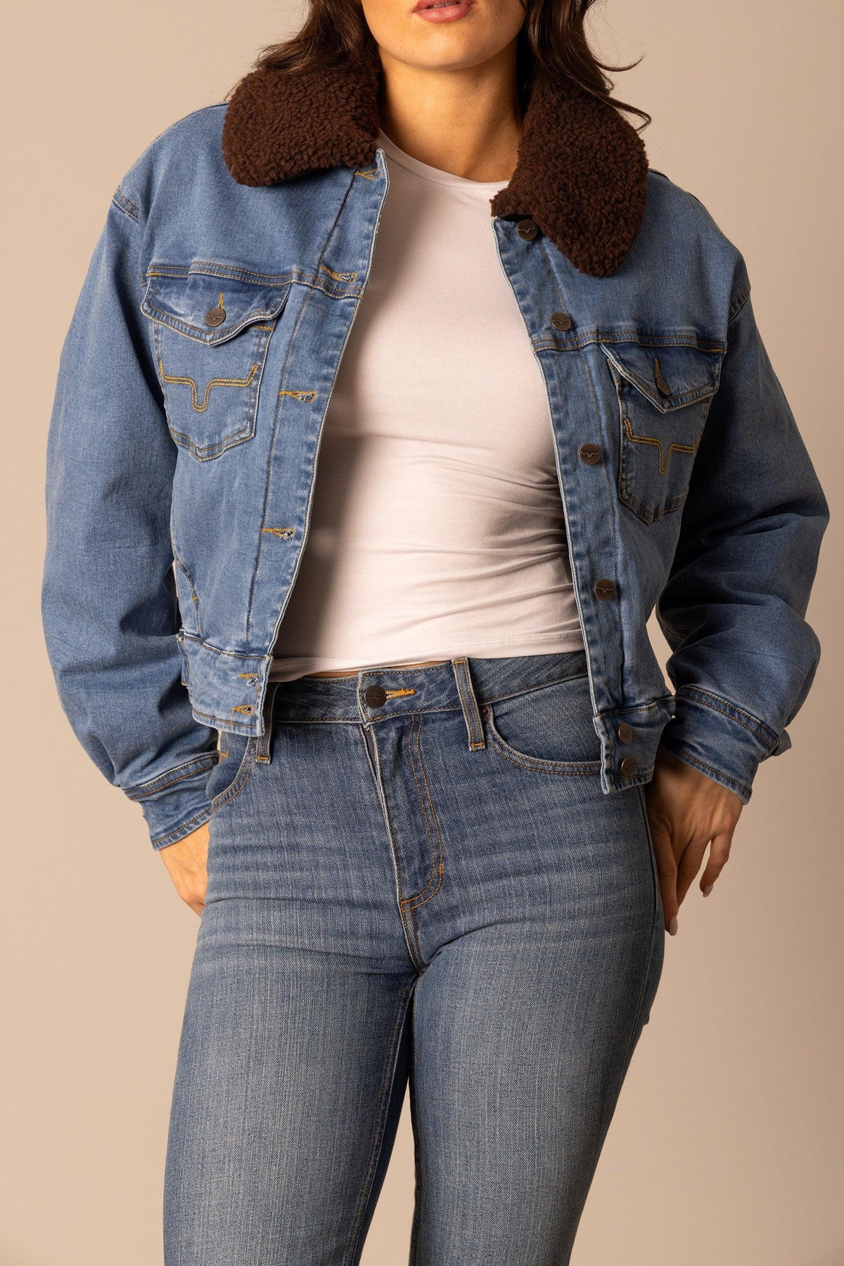 Kimes Ranch Leela Denim Jacket in Light Wash Indigo with brown sherpa collar and longhorn logo on chest pockets
