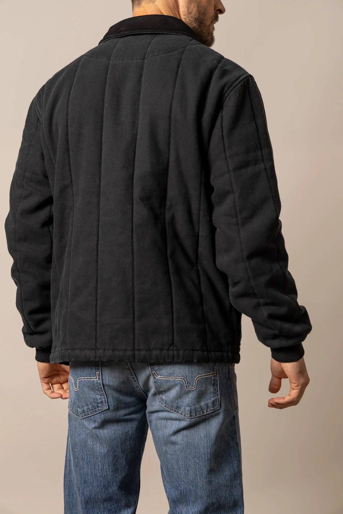 Kimes Ranch Lewiston Jacket in Black, back view, with a quilted back yoke and ribbed cuffs