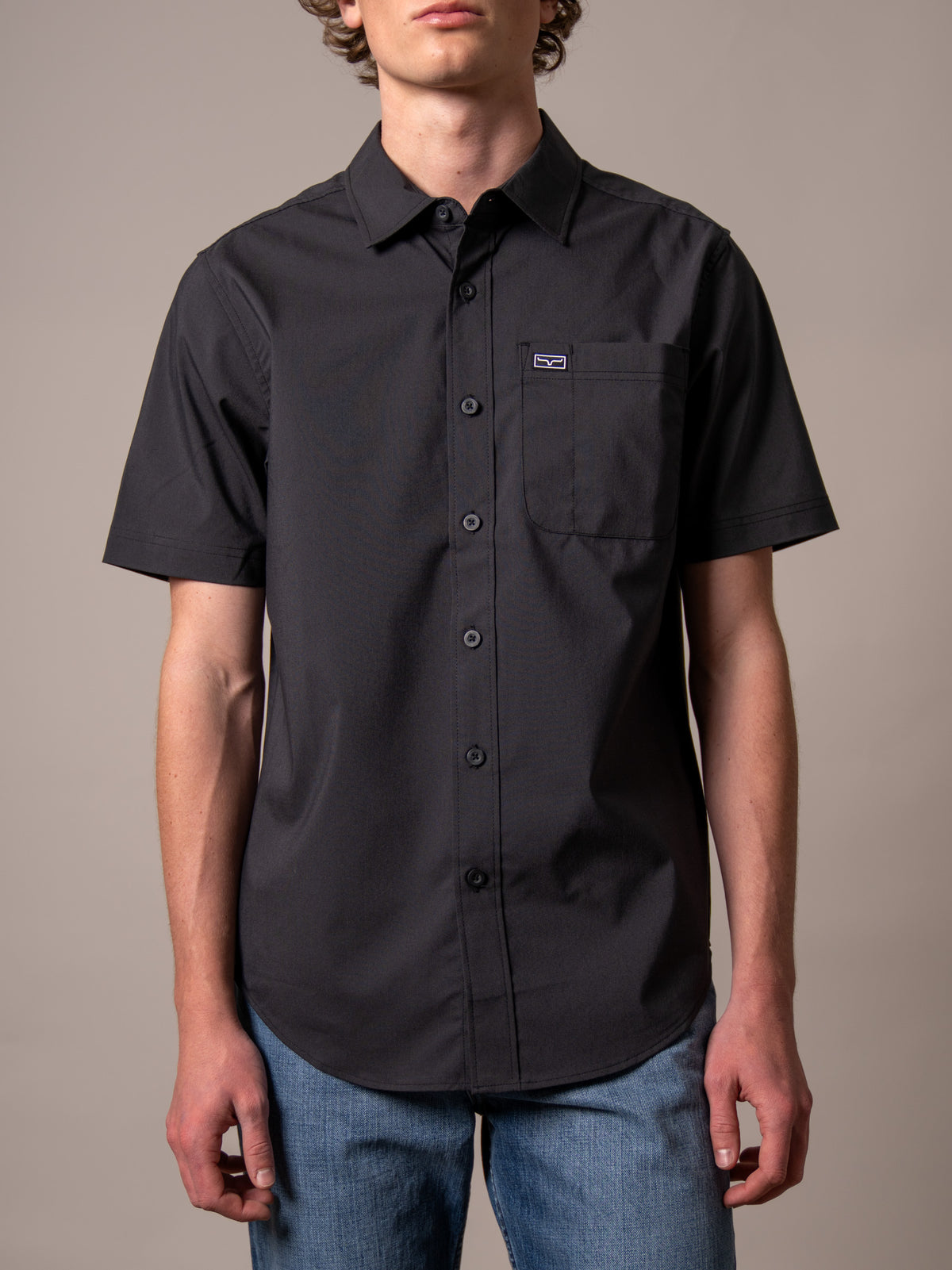 Kimes Ranch Linville Short Sleeve Dress Shirt in Black with a button front and chest pocket with logo