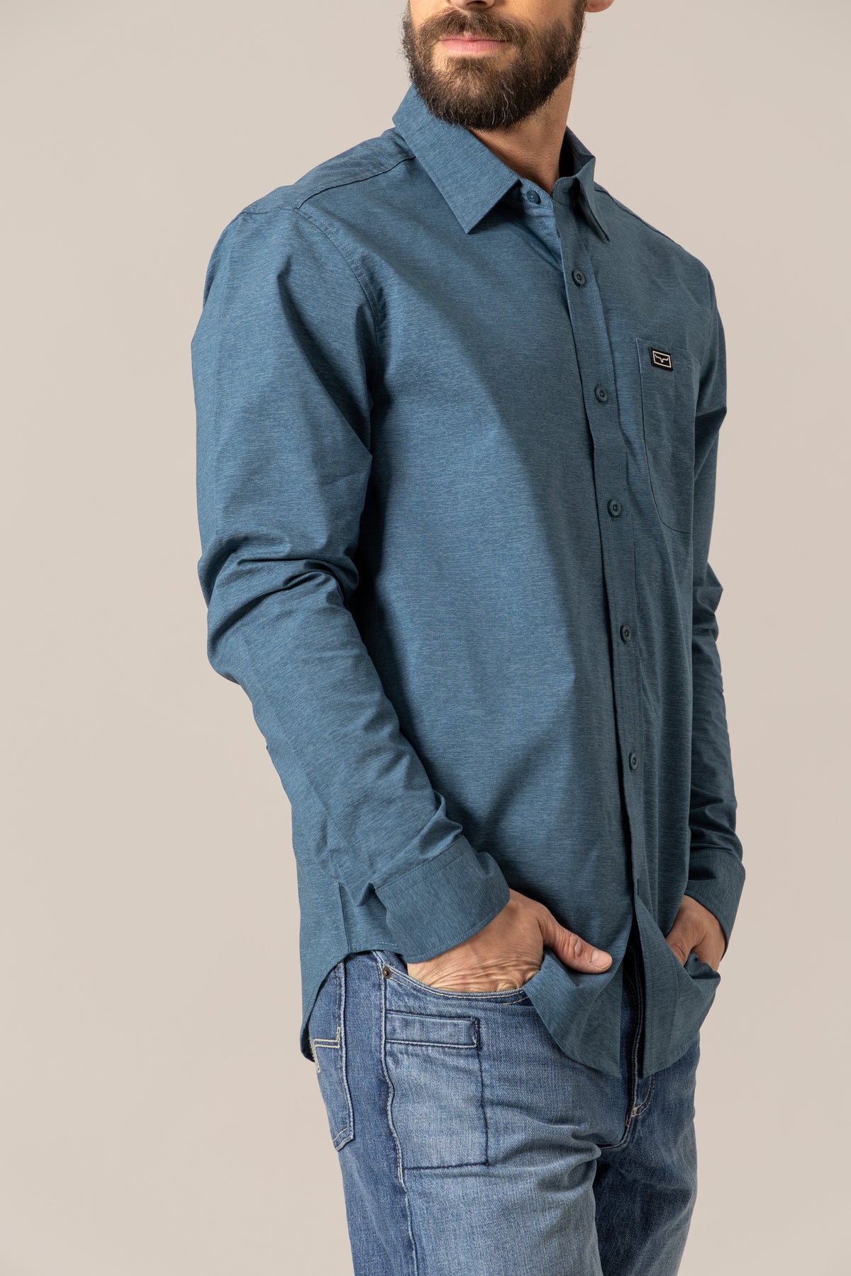 Kimes Ranch Linville Long Sleeve Dress Shirt in Dark Blue, side view, with a chest pocket and logo