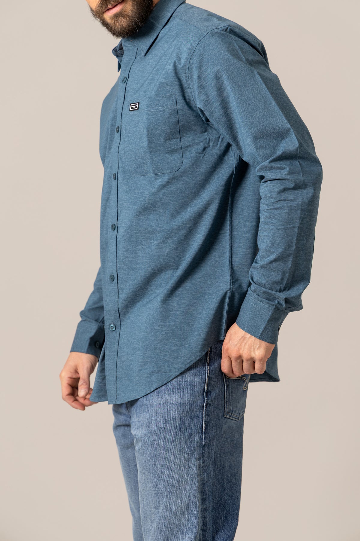 Kimes Ranch Linville Long Sleeve Dress Shirt in Dark Blue, side view, with a chest pocket and logo