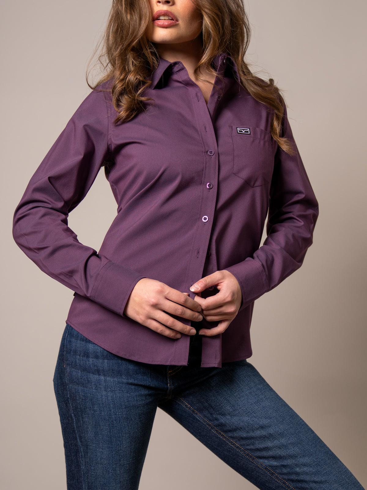 Kimes Ranch Ladies Linville top in Plum with long sleeves and a chest pocket with the Kimes Ranch logo