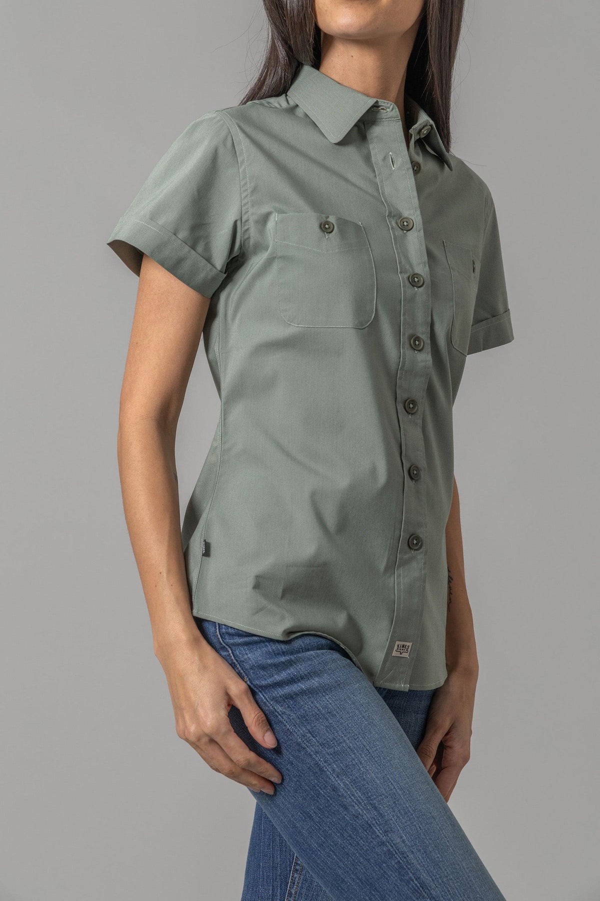 Kimes Ranch Ladies Linville Short Sleeve top in Pine, side view, with a collar, button front, and chest pockets