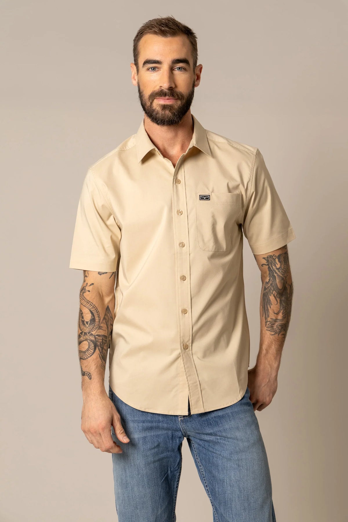 Kimes Ranch Linville Short Sleeve Dress Shirt in Tan with a chest pocket and logo patch